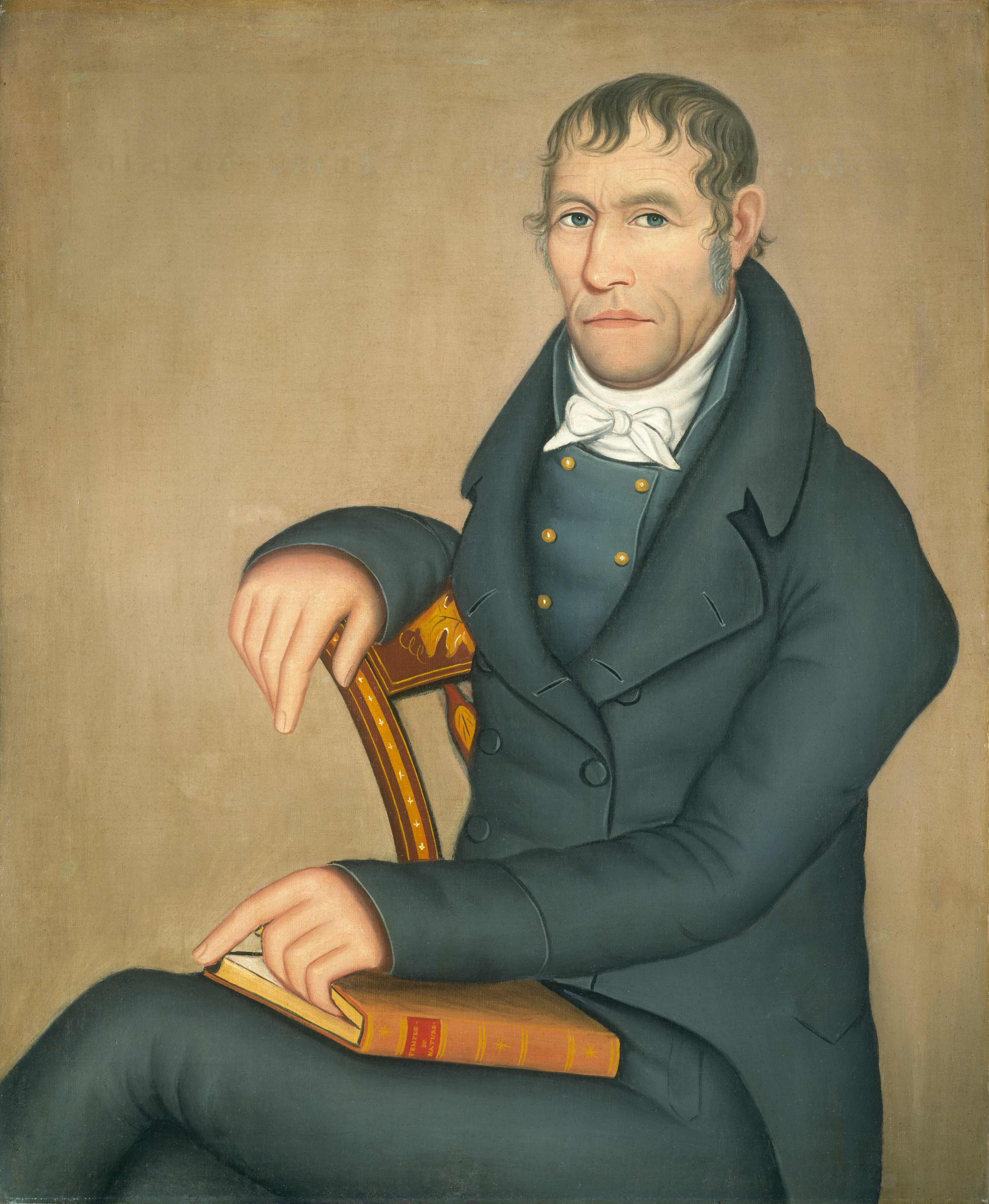 The image shows a man in a side-profile position. He has light blue eyes, a long nose, thin lips, and dark brown, wavy hair with sideburns. He wears a dark coat, a white high-collared shirt, and a white cravat. The man rests his arm on the back of a wooden chair and holds a closed book. The background is a neutral-toned canvas.
