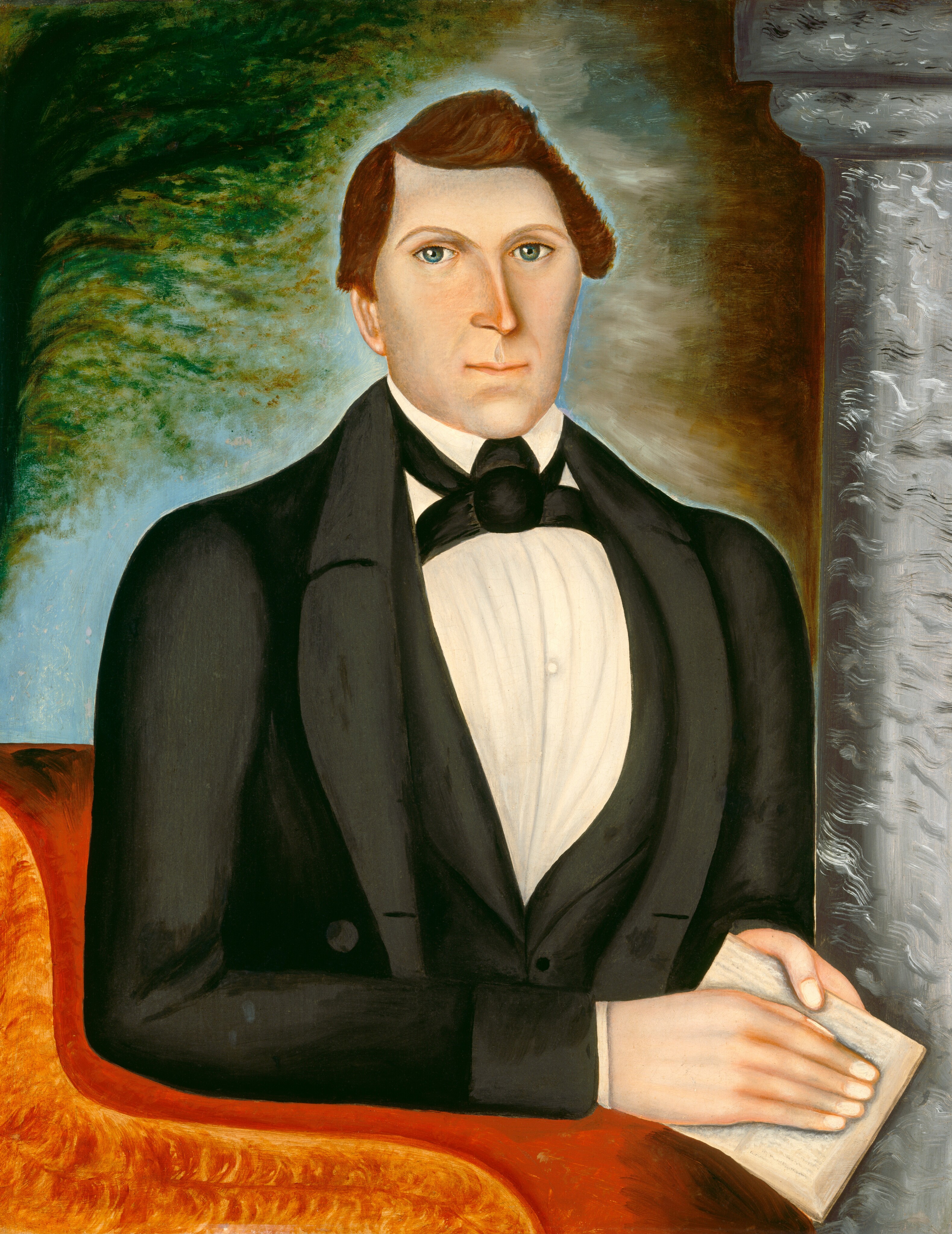 The image shows a man in a half-body portrait. He is seated, facing forward, with his torso and hands visible. His left arm rests on a surface. The man has angular features, light-colored eyes, brown hair styled to the side, and wears formal attire. He holds a book in his left hand. The background has a textured gradient with a pillar on the right and abstract greenery on the left.