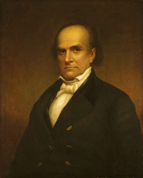The image shows an upper-body portrait of a person seated in a slightly turned position, looking directly at the viewer. The person has distinctive facial features, including a strong brow, deep-set eyes, a straight nose, and a firm mouth. Their hair is dark and receding, with tufts visible on the sides. They wear a formal outfit with a high-collared white shirt, a cravat, and a dark suit with wide lapels and two visible buttons. The background is plain, dark, and subtly gradient, emphasizing the person in the foreground. There is no jewelry or objects held by the person. The artwork is done in a classic, historical style against an indistinct brown backdrop.