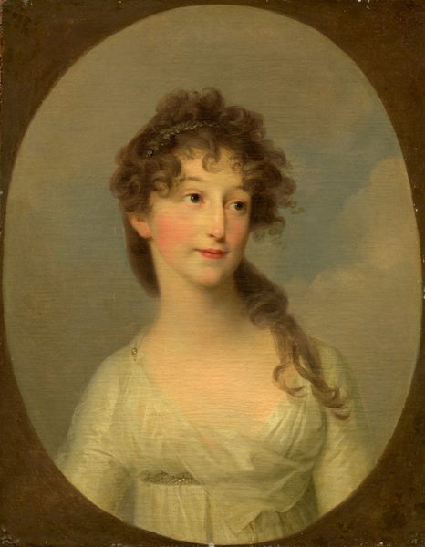 The portrait depicts the upper half of a woman's body. She is posed facing slightly to the side, with her head tilted and gaze averted. The woman has soft facial features, fair skin, rosy cheeks, and a subtle smile. Her brown curly hair is styled with volume on top and falls over her shoulder, and she wears a dark headband. She is dressed in a light gown with intricate details, set against a softly painted sky background with light clouds.