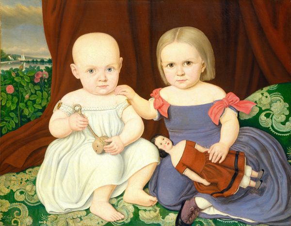 The image depicts two young children seated next to each other. The child on the left is seated on the floor, holding a rattle. They have a round bald head, light eyes, and wear an off-white dress. The child on the right is holding a doll, has light blonde hair, and wears a purple dress. They are surrounded by a green carpet and a brown curtain. In the background, there is greenery, pink flowers, a sailboat on water under a blue sky with clouds.