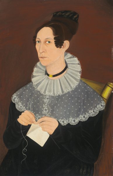 The image shows a woman seated and facing slightly to her right. She is sewing or embroidering a white piece of fabric. She has distinct facial features, fair complexion, light blue eyes, and brown hair styled in a bun with two curls draping over her forehead. She wears a black outfit with a white lace collar that extends over her shoulders. A black choker with a gold element is around her neck. She sits on a chair with a visible brass or gold element on the edge. The background is a dark reddish-brown color.