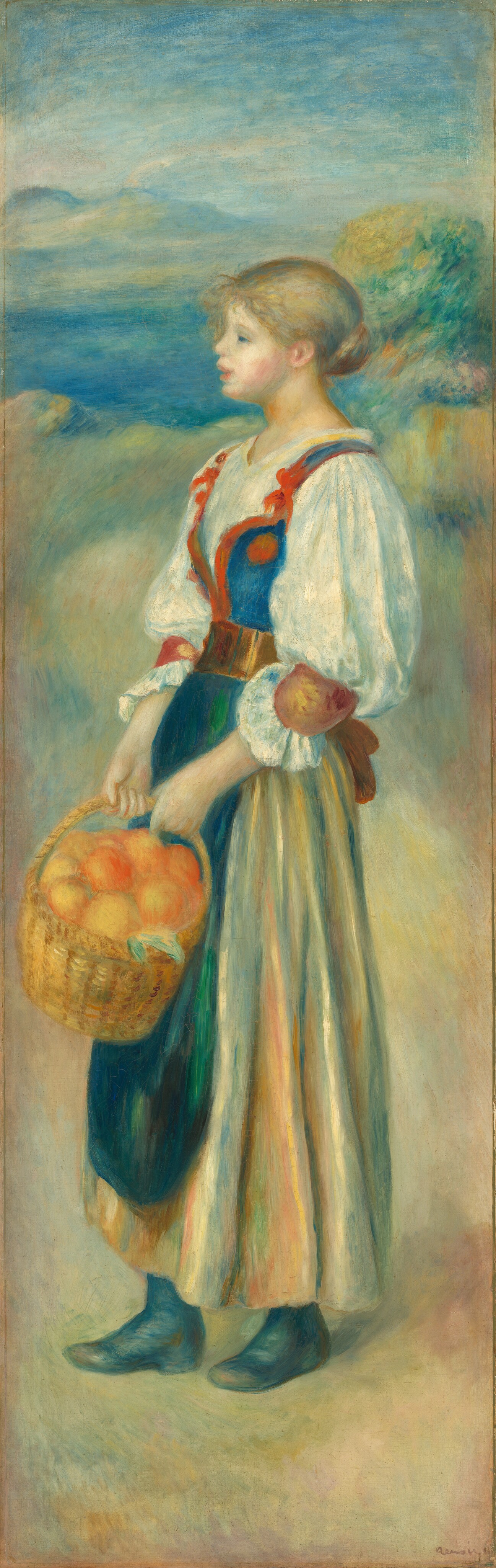 This painting shows a young woman standing in profile, facing the left and holding a basket of orange-yellow fruit. She has fair skin and light brown hair in a low bun, and she is wearing a dress with a blue vest, white sleeves, a tan skirt, a brown belt, a dark green apron, and black boots. The background includes tan ground, pale green foliage, blue water, and a pale blue sky. The brushstrokes in the painting are soft and visible.