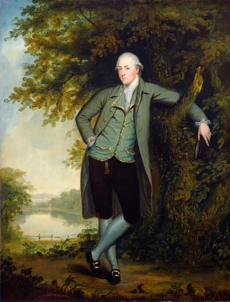 The image displays a man in 18th-century attire standing against a tree. He has fair skin and powdered white hair. He is elegantly dressed in a green coat, blue waistcoat, white cravat, dark breeches, blue stockings, and black shoes with gold buckles. The man is holding a three-cornered hat, standing with one arm on a tree branch, legs crossed at the ankle, with a calm expression and a slight smile. The background features a tree, serene landscape with foliage, a reflective body of water, distant hills, and a cloudy sky.