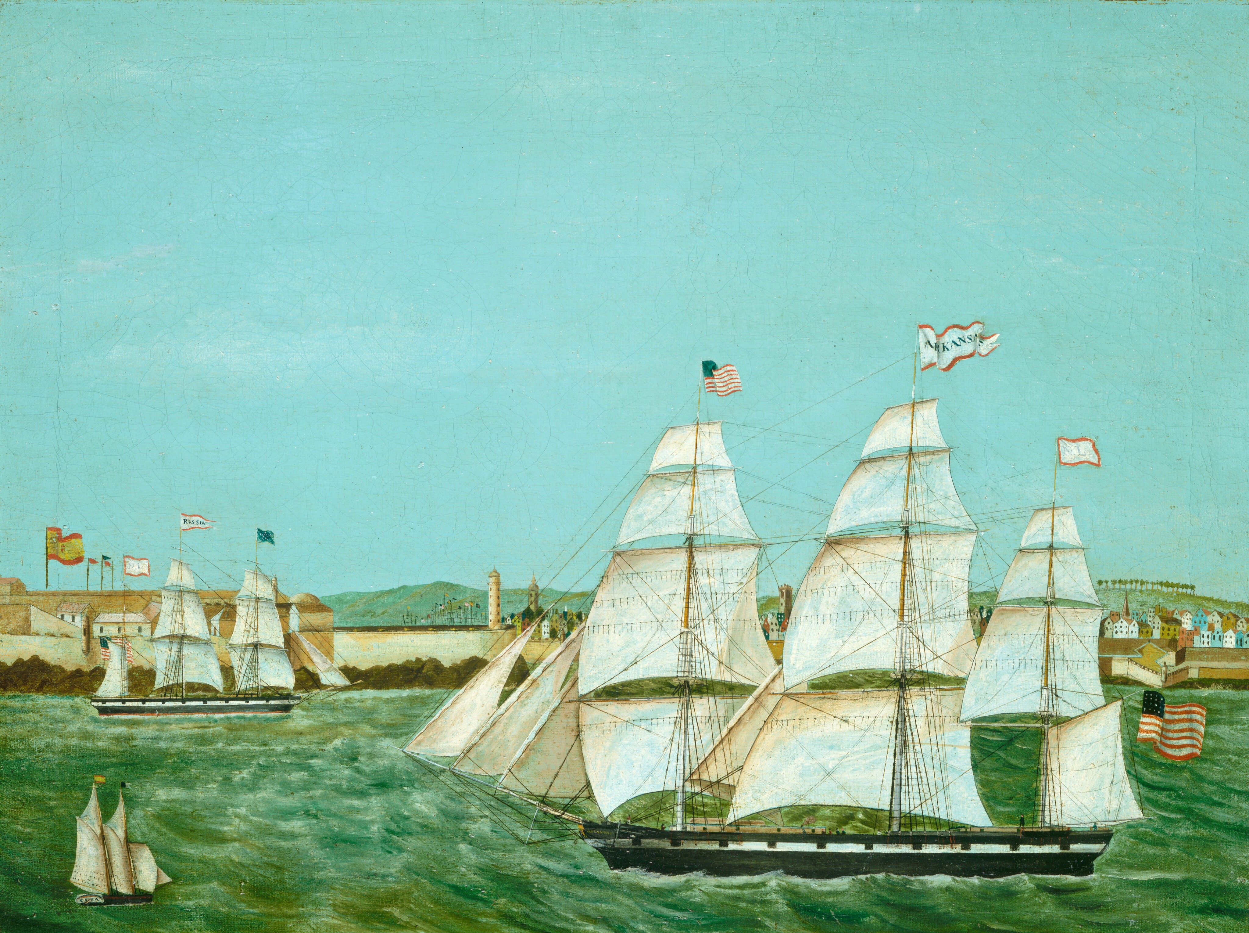 This painting shows a maritime scene from the water, with a coastline in the distance marked by small, colorful buildings and distant green hills. Closer to us, a large ship with white sails floats on the green waves, flying the American flag and a flag that appears to have the word "Arkansas." Miniscule figures are visible on the deck of the ship, and thin ropes crisscross the three tall masts. On the left are two smaller ships. The one in the back flies a flag that says "Russia," while the closer ship near the bottom left corner has a design on the back that appears to say "Cuba." The sky above is bright blue, uninterrupted by clouds.