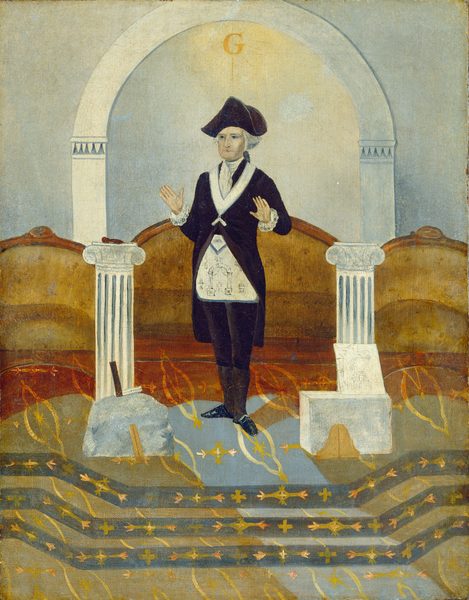 The image shows a man standing at the center. He is facing forward with his hands slightly raised at his sides. He has a serious expression and wears a tricorne hat. His hair is white or gray, styled beneath the hat. The man wears dark formal attire with a white collared shirt visible beneath, and a white apron with symbols. To his right, a column supports an object, and on his left, there's another column, a stone with a tool, and a small structure resembling a seat. The background has an archway with the letter 'G' displayed, and a patterned floor with golden and black designs. Surrounding the figure are brown and red tones.