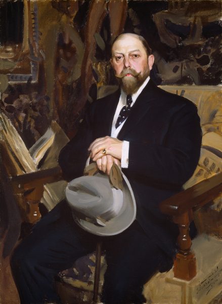 This painting shows a portrait of a middle-aged man who looks out at us. He is seated in a chair, turned slightly to the left, with his hands holding a gray hat in his lap. The man has pale skin with a brown mustache and a neatly trimmed beard, and his hair is slicked back and appears to be balding. He is wearing a dark suit with a white shirt and a patterned tie. On one of his fingers, he wears a gold ring. The background of the painting is an ornate interior, with richly patterned wallpaper, drapery, or furniture suggested by thick brushstrokes in shades of brown, tan, and black.