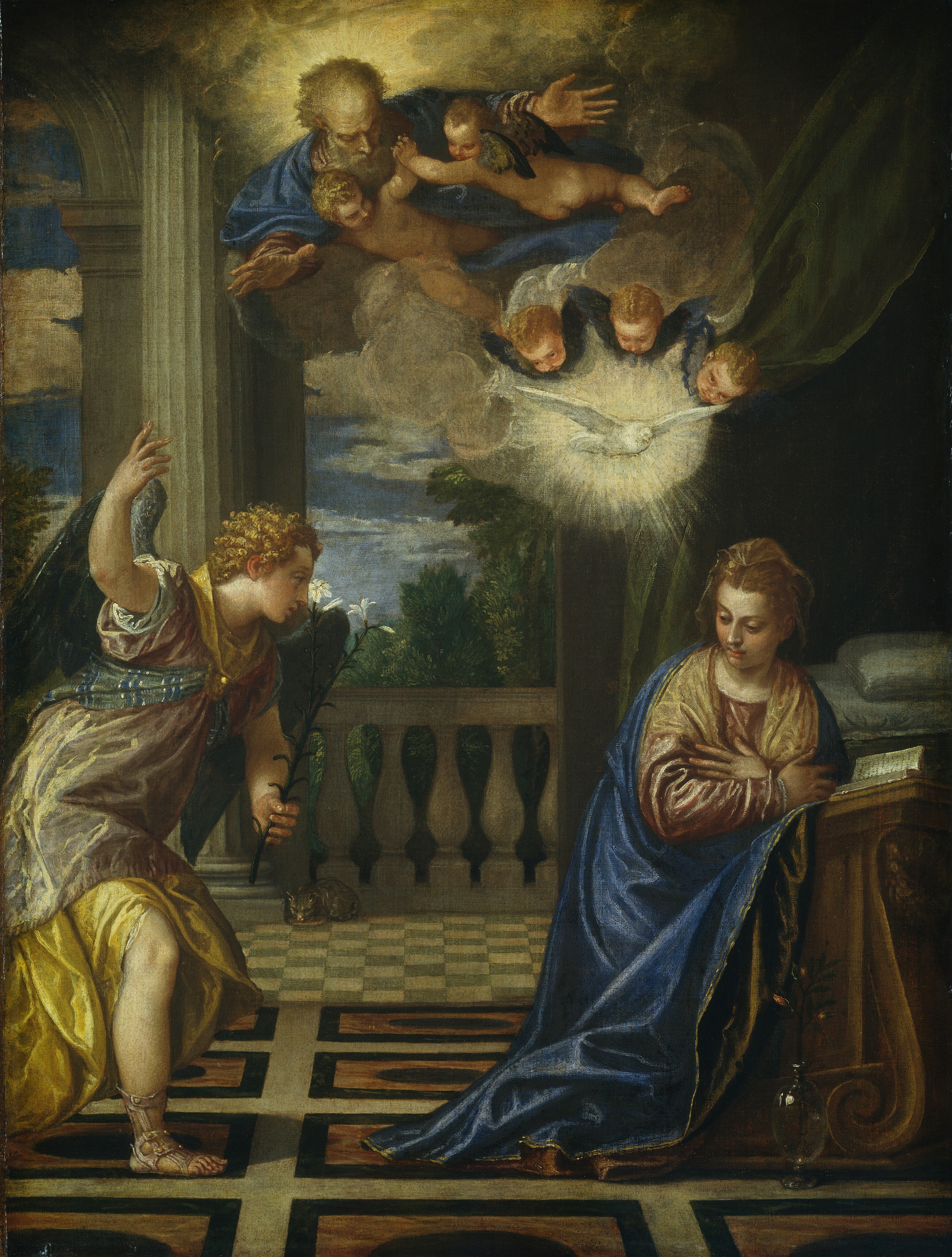 A winged angel strides toward a young woman who kneels at the foot of a bed, while an older, bearded man, surrounded by several winged babies and a dove, hover overhead in this vertical painting. All the people have pale skin. To our left, the blond angel steps forward on his right, sandaled foot. He holds a long stem with a white lily in his left hand, farther from us, and raises his other hand to the sky. His charcoal-gray wings are partly extended, and he wears long, flowing, goldenrod-yellow and sage-green garments with a green and blue striped sash wrapped around his chest. His lips are parted, and he looks toward the woman to our right. The woman, Mary, kneels at a wooden lectern that holds an open book near the foot of the bed. Pillows and a moss-green bed curtain are visible behind her. A cobalt-blue mantle drapes across her shoulders and wraps around her rust-red gown and caramel-brown shawl. Mary’s brown hair is partially covered by a golden brown cloth, and her dark eyes are lowered, looking down to our left. Her body is angled to our right, hands crossed over her chest, but her shoulders and head have begun to turn to look back at the angel. Almost lost in shadow, a translucent glass vase with a single stem of rose-red buds sits on the ground next to her. The floor is covered with geometric patterns in tones of brown, gray, and black. A balustrade under arched openings encloses the room beyond the bed. At the foot of one column, a striped cat laps from a saucer. Floating above the pair the bearded man looks down toward Mary, his hands and arms extended in front of him. He also wears a cobalt-blue robe over rose-pink sleeves. Two winged, nude babies cling to his outstretched arms, and also look down at Mary. A trio of three blond baby heads float around the white dove, which flies in a starburst of light. Midnight-blue wings frame each baby’s head. The entire group is surrounded by puffy, golden clouds. The landscape beyond the balustrade has lush green trees under a sapphire-blue sky sprinkled with clouds.