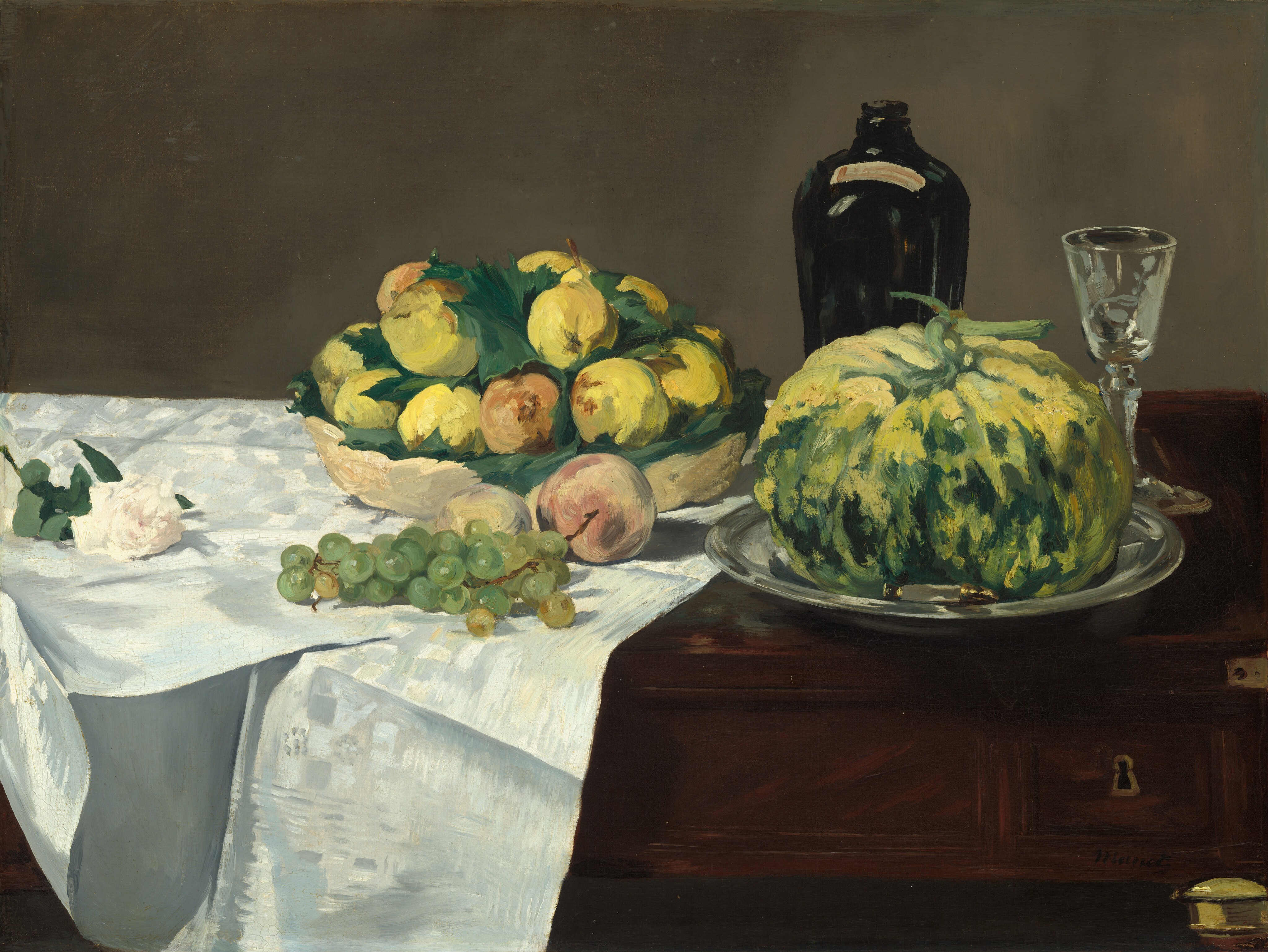 A white rose, grapes and other fruit, a squat gourd, a bottle, and a glass are arranged across a dark wood table partly covered by a white cloth in this horizontal still life painting. The table and its objects fill the width and most of the height of this composition, and are set against a sable-brown background. The rose, bowl, cluster of green grapes, and a peach sit on the shimmering, bright white cloth, which is draped over the left half of the table. The shallow, straw-yellow bowl holds a pile of canary-yellow pears and a few peaches nestled among green leaves. Another peach and a second piece of fruit sit in front of it, partly obscured by the grapes that lie near the front edge of the table. Continuing to the right, the pumpkin-shaped gourd, roughly the size of the bowl and its fruit, is painted with streaks and daubs of lemon yellow and light and forest green. It sits on a gleaming silver tray. A tapered, earth-brown bottle and a small glass with a long stem stand behind the gourd. On the front face of the table, near the lower right corner, a keyhole is outlined with gold, and the top of one table leg is also gold. The objects are loosely painted with some visible brushstrokes, especially in the fruit in the bowl and the gourd. The artist signed the lower right, "Manet."