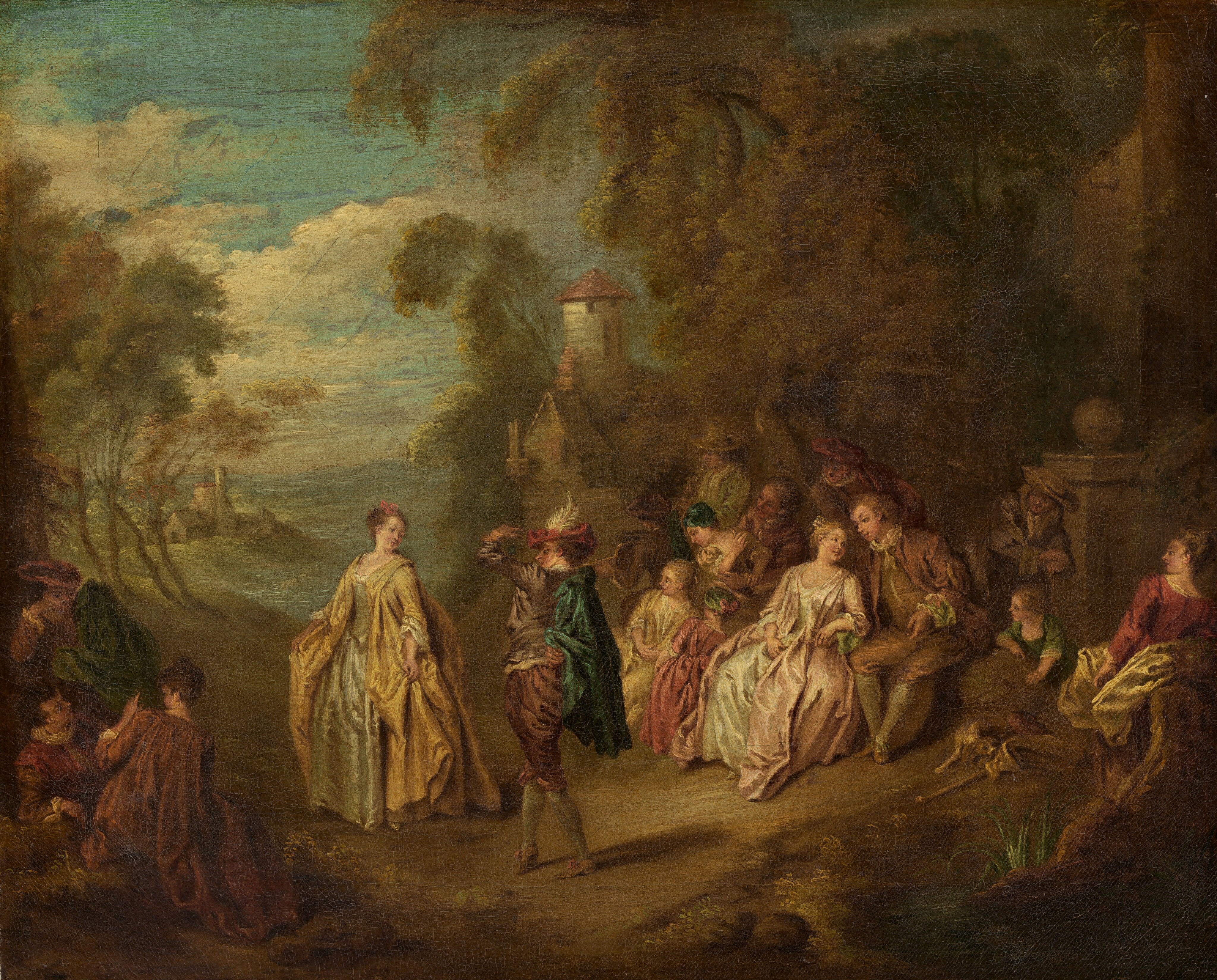 This painting shows a group of people gathered outdoors, surrounded by dark, olive-green trees. Elegantly dressed people with light skin interact, two standing in the center in between groups sitting on the left and right. In the center are a woman in a flowing yellow gown and a man with a green cape and a red cap with a tall white feather. The people sitting on either side, including men, women, and children, look towards the two in the center or turn towards each other, speaking. In the distance on the right, there is a gap between the tall trees, revealing a blue sky with white clouds above light-green grass and a few clusters of white buildings and towers with red roofs. The distant landscape gradually fades into a hazier, bluish tone towards the horizon.