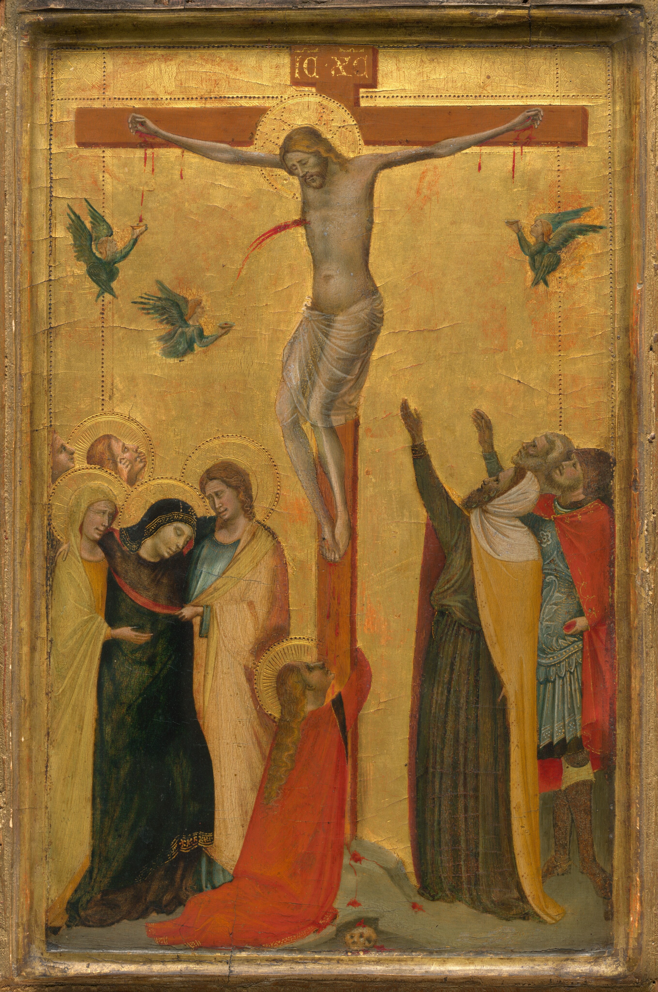 A man hangs on a cross flanked by small groups of people against a shiny gold background in this vertical panel painting. The people all have pale skin tinged with gray. The man on the cross, Jesus, has long blond hair and a beard, and he wears only a translucent white cloth wrapped around his hips. Blood trickles from nails driven through his hands and one driven through both feet. Blood also spurts from a wound over his right ribs. A halo surrounds his head, which hangs down, eyes closed. The wood cross is about twice as tall as the people standing around it, and a panel at the top has the letters “ICXC” written in gold. A woman with long, unbound blond hair and wearing a vibrant red cloak wraps her arms around the foot of the cross. That woman and four people in the group of five to our left also have halos. There, two people support a woman who has swooned between them. That woman wears a black cloak, and her supporters cry, their brows furrowed and eyes squinted. Two people behind this group, one of whom has a halo, look up at Jesus. To our right, three bearded men also look at the cross. The man closest to us wears a white hood and a canary-yellow cloak over a moss-green robe. He holds both hands up high. A man behind him wears a helmet and a red cloak over sky-blue armor, and we only see the lined face of the third man, who has a white beard and hair. Three angels catch the blood trickling from Jesus’s two hands and the wound on his side in shallow gold cups. Each angel has blond hair, wears a topaz blue, long-sleeved garment, and has two pairs of wings – one coming from their backs and another crossing in front of their torsos. The cross stands on a low mound on a rocky ground. A small human skull is tucked into an opening below the mound. The bright gold background is punched with lines to create an inner border behind the scene, and the panel is framed with gold molding.