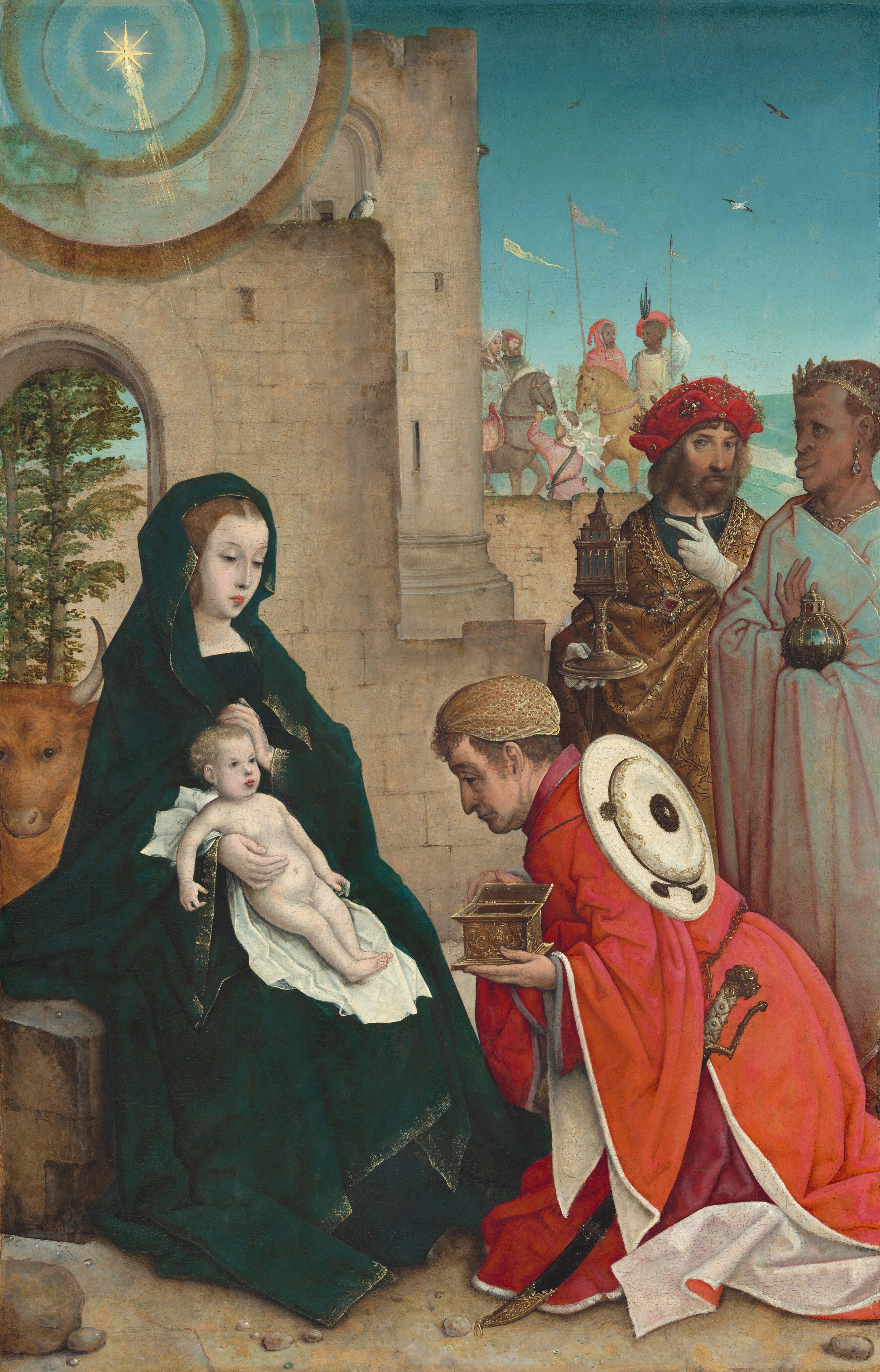 A pale, light-skinned woman holding a baby sits to our left in front of stone ruins as one man kneels and two men stand to our right in front of a landscape in this vertical painting. The woman wears a long, navy-blue coat trimmed in gold, and sits with her body angled to our right. Her light brown hair is parted in the middle and covered by the hood of her robe. She lowers her eyes toward a pale, naked, baby boy with curly blond hair, who leans back against her on a white cloth on her lap. She supports the baby’s side with her right hand and her left caresses his head. A man wearing a golden turban-like cap and a crimson-red, voluminous robe lined with white kneels on the dirt ground in front of the baby, and looks down and off to the side with dark eyes. The man has pale skin, a hooked nose, and jowls. A sword with a gold hilt hangs at his side and a round, white shield is slung over his shoulder. He holds a golden box open toward the baby. Two more men stand behind him. Cut off by the edge of the panel, the man on our right has brown skin, a flat nose, full, projecting lips, and he faces our left in profile. He wears a golden crown on short brown hair, and a large, teardrop-shaped pearl hangs from the ear we can see. His turquoise-blue robe is shaded with petal-pink in the shadows in the folds, and it partially covers a gold chain. He holds a gold-encrusted, jeweled orb in his hands. Beyond him, to our left, a man with pale, peach-colored skin stands facing and looking at us. He has a brown beard and his curly hair is covered by a crown set into a crimson-red, jeweled hat. He wears a gold, brocade robe over a navy-blue garment, and a large jewel pendant hangs from a thick gold chain around his neck. He points with a white gloved hand toward the woman and baby and, in his other, holds a gold vessel with a stem and foot like a wine glass. Behind the woman and to our left, a horned ox looks out toward us from under an arch in the stone ruins. Trees grow in the background and above, a golden star is encircled with bands of gold and blue, with rays extending toward the scene below. Nearby, a white and gray bird perches on the top of the ruins. In the background behind the men, two pairs of men on horseback and one man attending to one of the horses gather in a grassy landscape below a pale blue sky. The pair to our left have pale skin and the pair to our right have brown skin.
