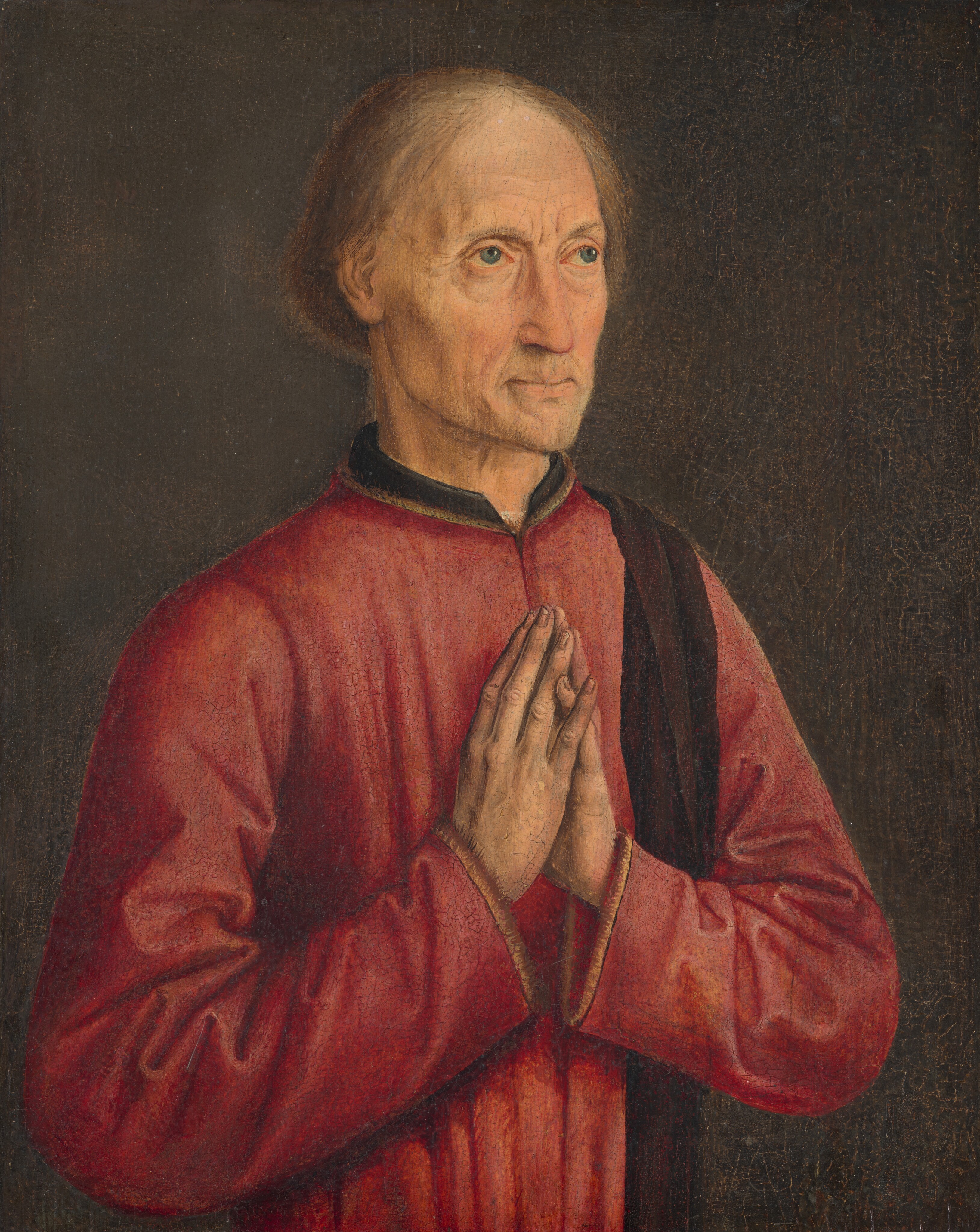 Shown from the waist up, a pale-skinned man is angled slightly to our right with his hands together in prayer in this vertical portrait painting. The man’s slightly bulging blue eyes lift to look up and to the right. Wrinkles line his forehead and the corners of his eyes and lips. His cheeks are hollow, and the temple we see slightly sunken. He has a long nose, bags under his eyes, and his thin lips are pressed together in a line over a pointed chin. Straight brown hair parts to either side of his high forehead and falls to just beneath his ears. His raspberry-red shirt has a high black collar, and a dark, burgundy red scarf drapes over his far shoulder. All of his fingertips touch except for the pinkies, which pass each other to make an X shape. The man is evenly lit against a brown background.