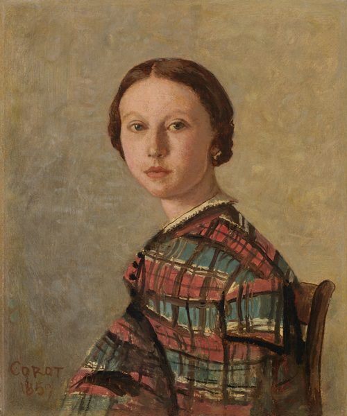 This painting depicts a young woman from the chest upwards, seated in a slightly turned position to the left. She has pale skin, reddish-brown hair styled back in a low bun, green eyes, and small pink lips that are slightly turned up at the ends. She is wearing a patterned garment with a plaid design in pink, light blue, and brown, featuring white trim around the neckline, along with some small black buttons. The background is a mottled gray with shades of light yellow and pale blue. The painting is signed "Corot" and dated "1859" in the bottom left corner.