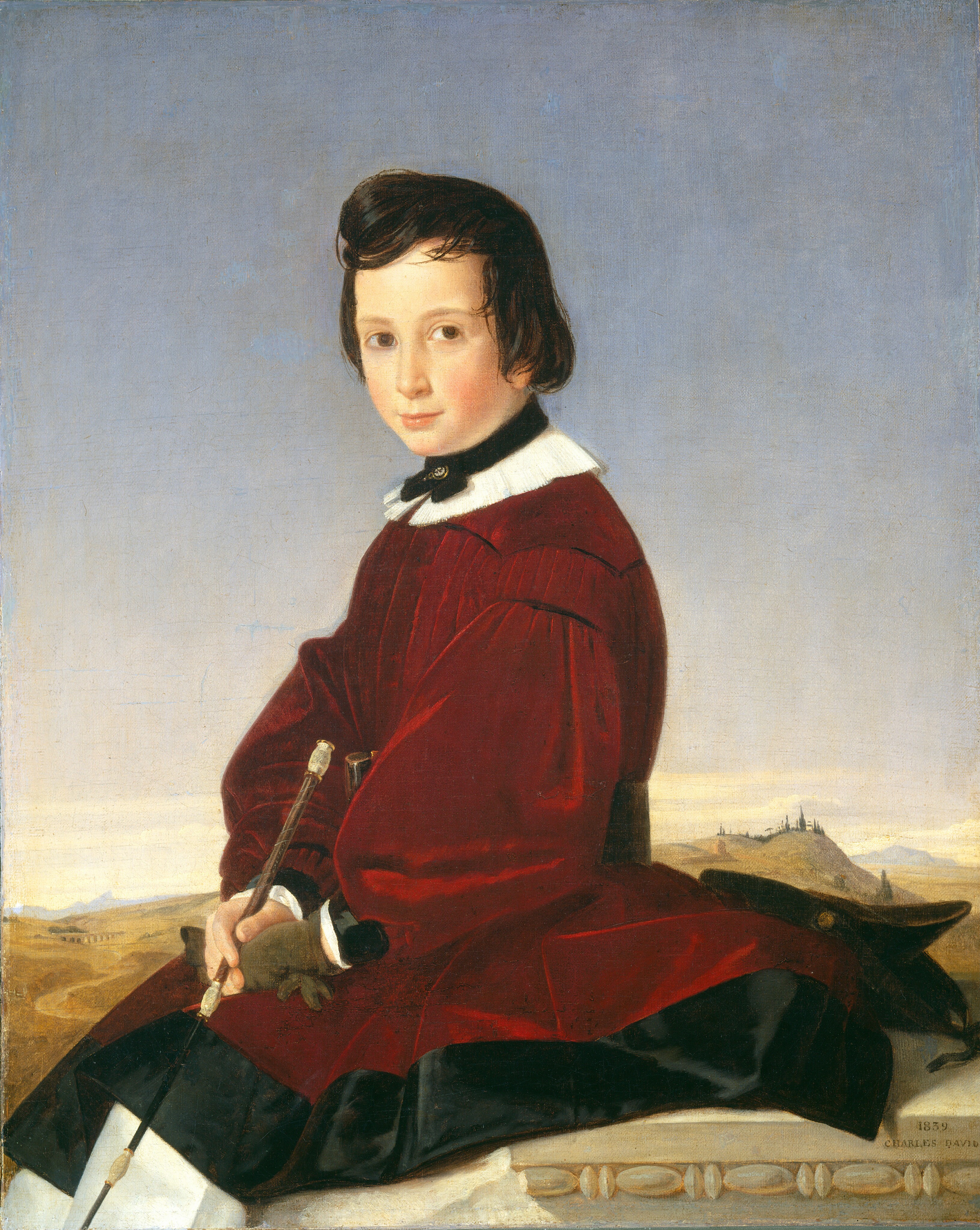 The image depicts a young person seated in a slightly side-facing position. They have fair skin, brown eyes, and medium-length hair styled in a neat cut. The person is wearing a red garment with black accents and a white collar, holding a slender stick in gloved hands. In the background, there is a pastel sky, rolling hills, and faint buildings. The setting appears to be outdoors, with the person seated on a stone ledge with decorative elements.
