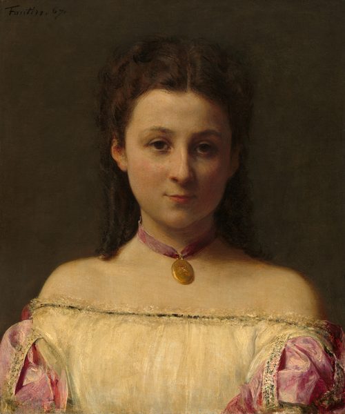 Shown from the chest up, a young, pale-skinned woman faces and looks out at us with a slight smile on her lips in this vertical portrait painting. The woman has a square face with round, dark, close-set eyes, thin lips, flushed cheeks, and a pointed chin. Her dark brown hair is parted down the middle and pulled loosely back, and ringlets fall to her shoulders. She wears a rose-pink ribbon as a choker with a gold, oval locket. The straight neckline of her off-the-shoulder dress is edged with frothy lace around narrow black trim. Pink, puffy sleeves have a sheen, suggesting silk or satin. Light falls across the woman’s face from our left, and the background is dark brown. The artist signed and dated the painting in the upper left corner, “Fantin. 67.”