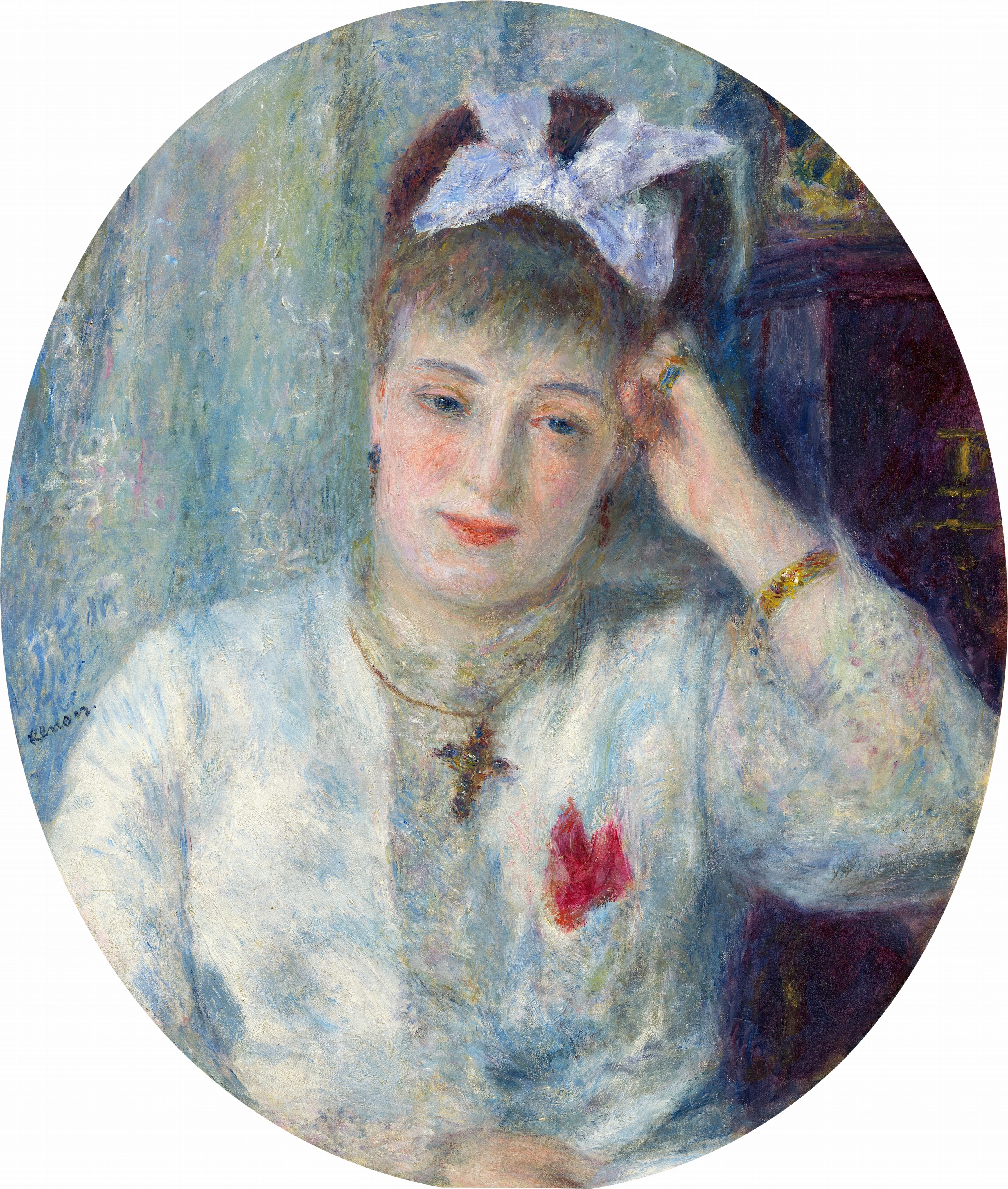 This painting is an oval portrait of a woman from the waist up. She faces us with her head slightly tilted to one side and resting on her right hand, her right elbow bent on a brown surface. She has pale skin, rosy cheeks, red lips in a slight smile, and brown hair in an updo and adorned with a white bow. She is wearing a light-colored garment with a red adornment on the right side, perhaps a flower or a brooch, as well as a dark necklace with a cross-shaped pendant, a gold bracelet on her left wrist, and a ring on her pinky finger. The background on the left consists of swirling colors in blues and greens, while the right contains a tall brown object that could be a dresser or a desk. The brushstrokes are thick and visible.