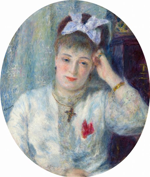 This painting is an oval portrait of a woman from the waist up. She faces us with her head slightly tilted to one side and resting on her right hand, her right elbow bent on a brown surface. She has pale skin, rosy cheeks, red lips in a slight smile, and brown hair in an updo and adorned with a white bow. She is wearing a light-colored garment with a red adornment on the right side, perhaps a flower or a brooch, as well as a dark necklace with a cross-shaped pendant, a gold bracelet on her left wrist, and a ring on her pinky finger. The background on the left consists of swirling colors in blues and greens, while the right contains a tall brown object that could be a dresser or a desk. The brushstrokes are thick and visible.