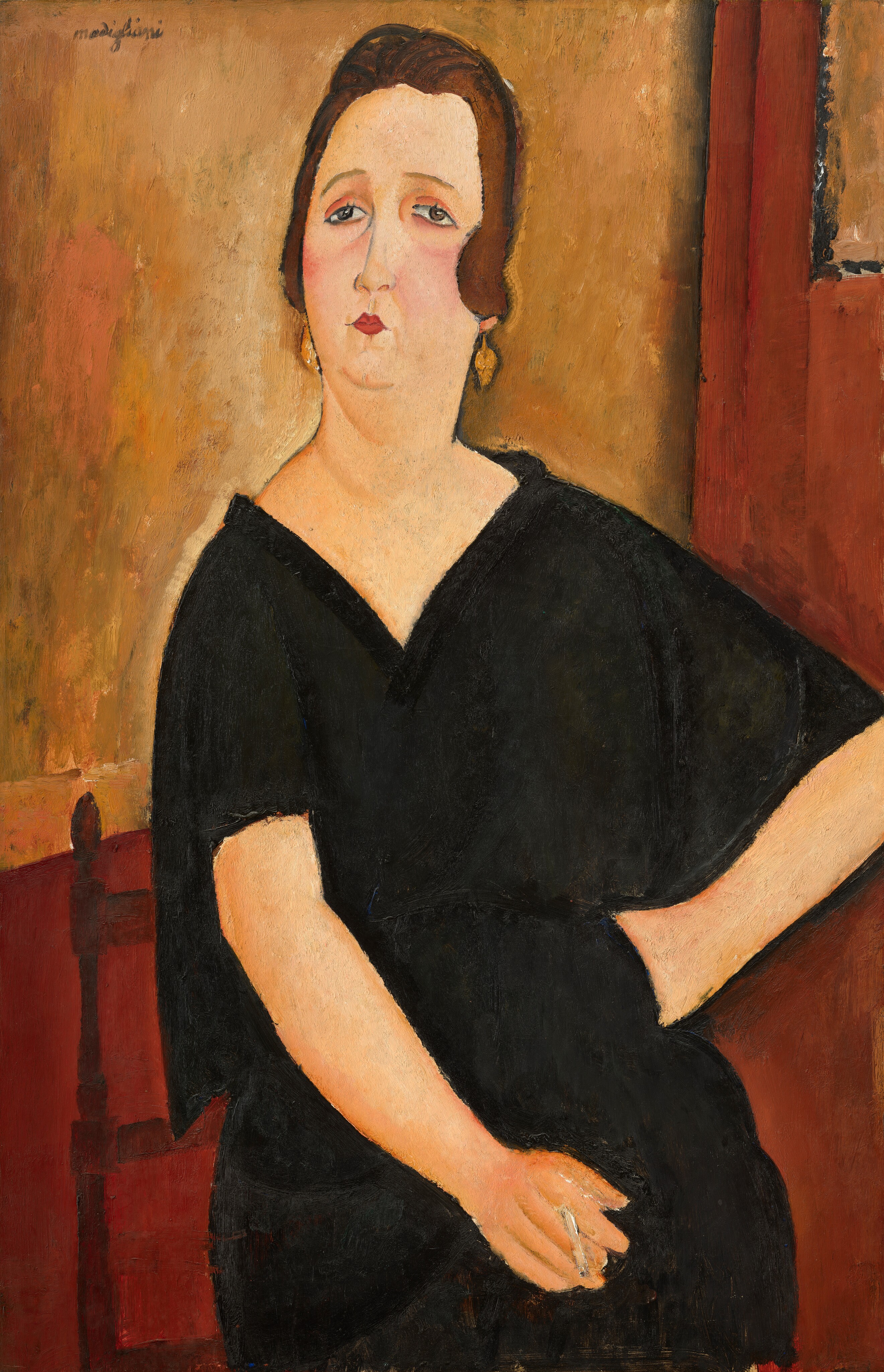 This painting shows a portrait of a woman, depicted from the thighs up. She is seated with her body and head facing forward. She has pale skin, rounded cheeks with a slight blush, a small, red mouth, thin eyebrows, and lined eyes that slant downward towards her ears. Her brown hair is styled in waves, framing her face. She is wearing a black dress with a V-neck, and in her ears are dangling gold earrings. Her left hand is on her hip, with her right resting on her crossed legs, a cigarette between her fingers. She is sitting on a red wooden chair, and the background is a vibrant red color with earthy yellow sections in the top left and right corners.