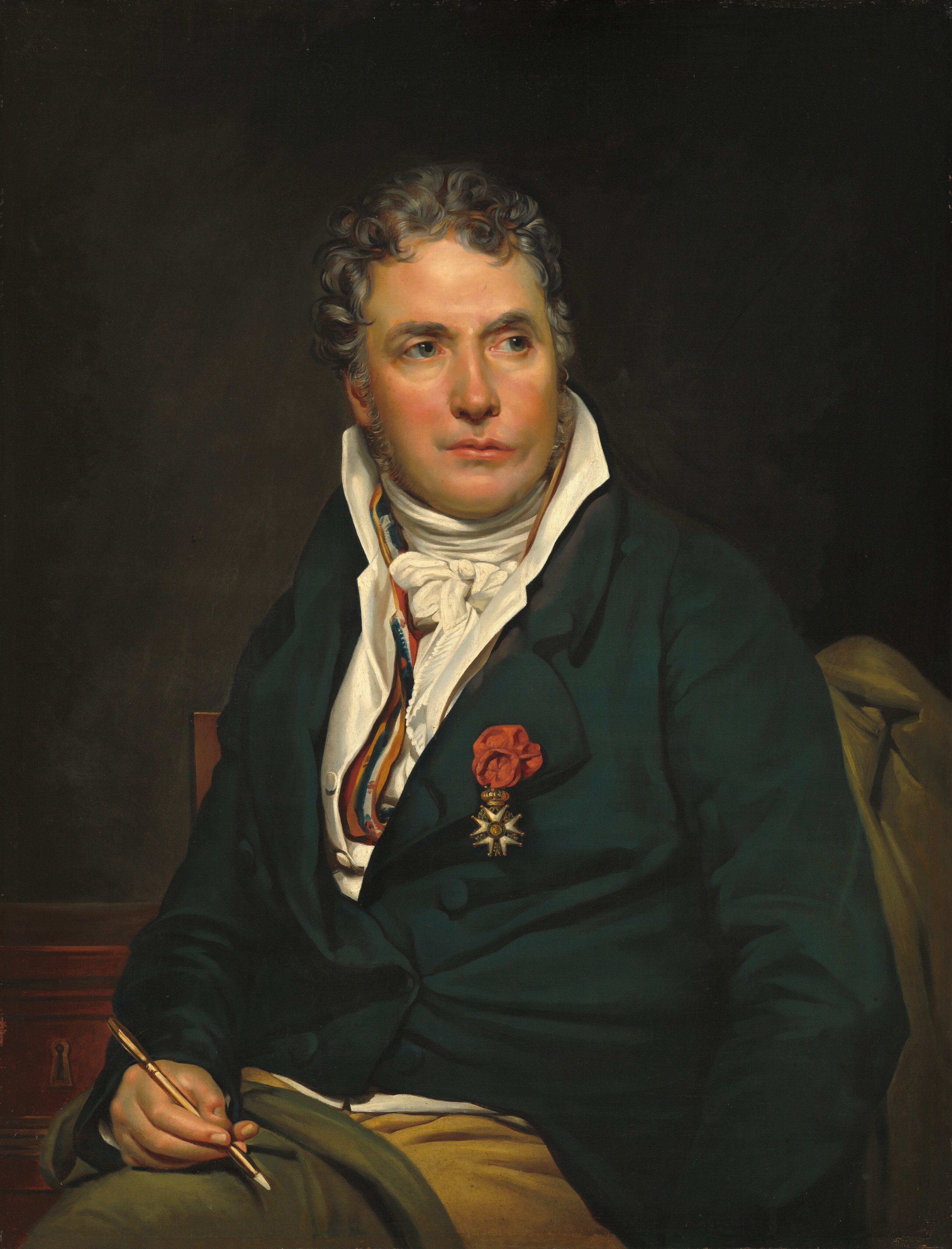 This painting is an upper-body portrait of a seated man. His body is turned to the left, while his face is turned to the right. His facial features include a fair complexion with a ruddy glow on his cheeks, prominently arched gray eyebrows, gray eyes, and pink lips that appear to be uneven, with the left side higher than the right side. His hair is short, gray, and wavy. The man is dressed in formal attire, wearing a dark green-blue coat over a white waistcoat and a white cravat around his neck, with a striped yellow, red, blue, and white shirt peeking out around his collar. He has a red flower pinned to his lapel, and hanging from it is a gold-and-white medal shaped like a star. He holds a quill pen in his right hand, resting it on an olive-green cloth spread across his knees. The background is dark gray, with a hint of a reddish wooden cabinet or chest in the bottom right and a gray cloth or coat hung on the right.