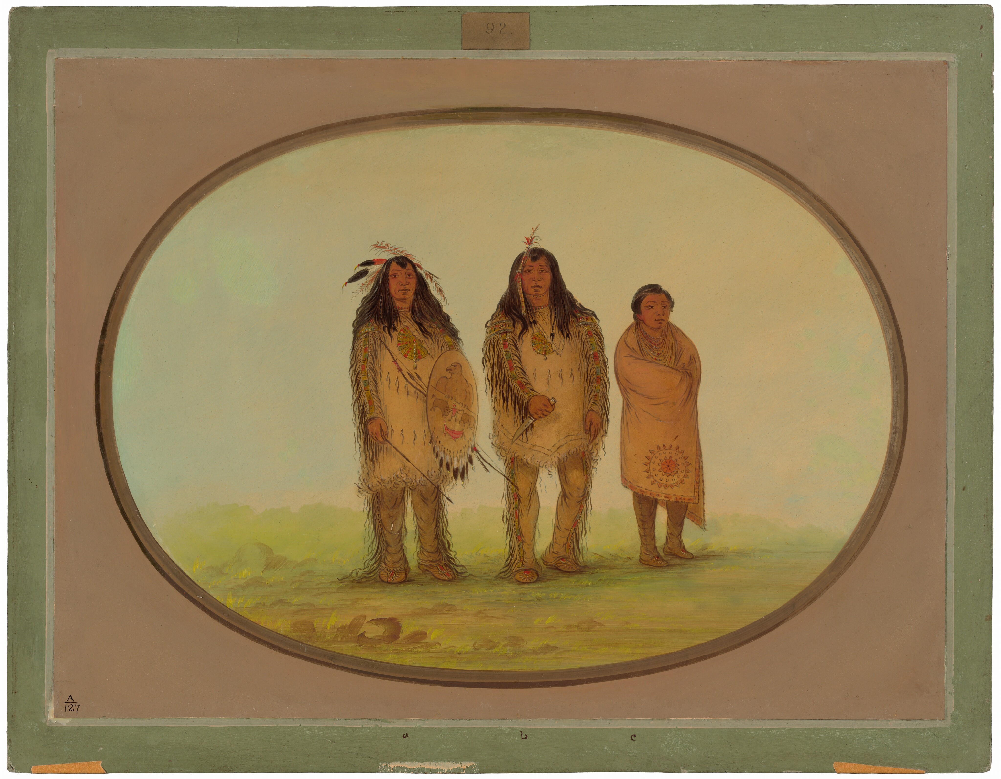 Three figures stand side by side in an outdoor setting. The person on the left is facing forward, holding a shield. They have long dark hair with feathers and wear a fringed outfit. The central figure also faces forward, wearing a similar fringed outfit with long dark hair and a feathered headpiece. The person on the right stands with arms under a blanket adorned with a circular emblem, appearing wrapped warmly. The background shows a gradient sky transitioning from blue to yellow and green, suggesting an open landscape with light grass.