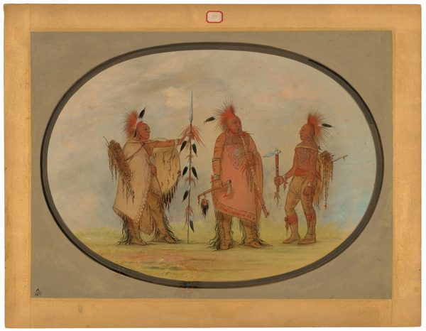 The image shows three Native American individuals standing outdoors. Their full bodies are captured in a standing position. The person on the left is dressed in a fringed and beaded robe and is holding a long spear decorated with feathers. This individual has a distinct headpiece with feathers pointing upwards and is depicted with a quiver bag over their shoulder. The central figure wears a long, elaborately beaded tunic, a bold necklace, and holds an axe. They display a headpiece similar to the left figure, with strong cheekbones and an engaged expression. The person on the right wears a red shirt with intricate design and fringed pants, holding another axe. This individual also wears a feathered headpiece, necklaces, and other decorative elements. All three individuals are set against a pale, open background of sky and ground, with faint blue and green tones suggesting a grassy plain on a softly clouded day. The scene is framed in an oval shape, with a parchment border surrounding it.