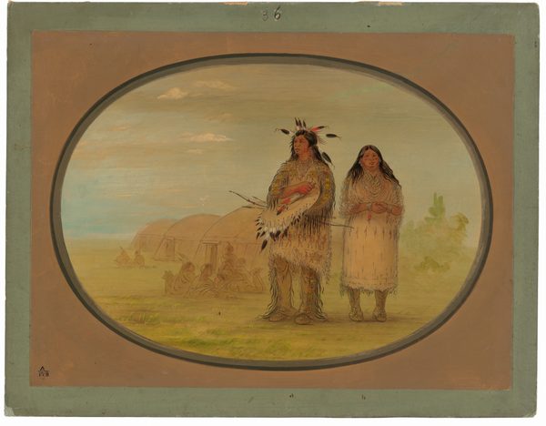 The image shows two figures depicted from head to toe standing side by side. On the left is a man with long hair adorned with a feathered headdress. He has a mustache and a stern facial expression, and he is wearing elaborate traditional clothing decorated with colorful beadwork and fringes. The man is holding a pipe and a large ceremonial shield, which is also decorated with feathers. Next to him is a woman with long dark hair, wearing a dress with beaded detailing and fringes at the hem. Her hands are clasped together in front of her. She wears several strands of necklaces. In the background are several dome-shaped structures, likely traditional dwellings, with faint figures or bundles in front of them. The sky is light blue with some clouds, and the ground is grassy featuring light, earthy tones.