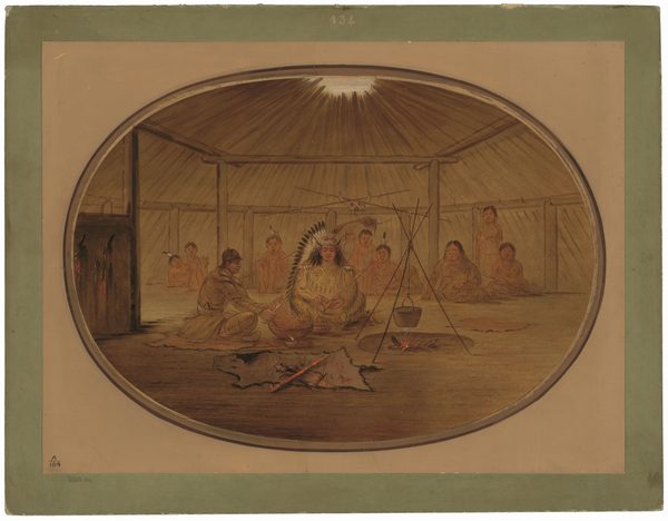 The image shows a group of six people seated inside a conical tent. One person, wearing a feathered headdress and traditional attire, sits at the center. Other individuals are seated around them, dressed modestly. There is a fire with a cooking pot, wooden posts supporting the tent, animal skins on the ground, and more people seated against the tent wall. Light filters in from an opening in the roof.
