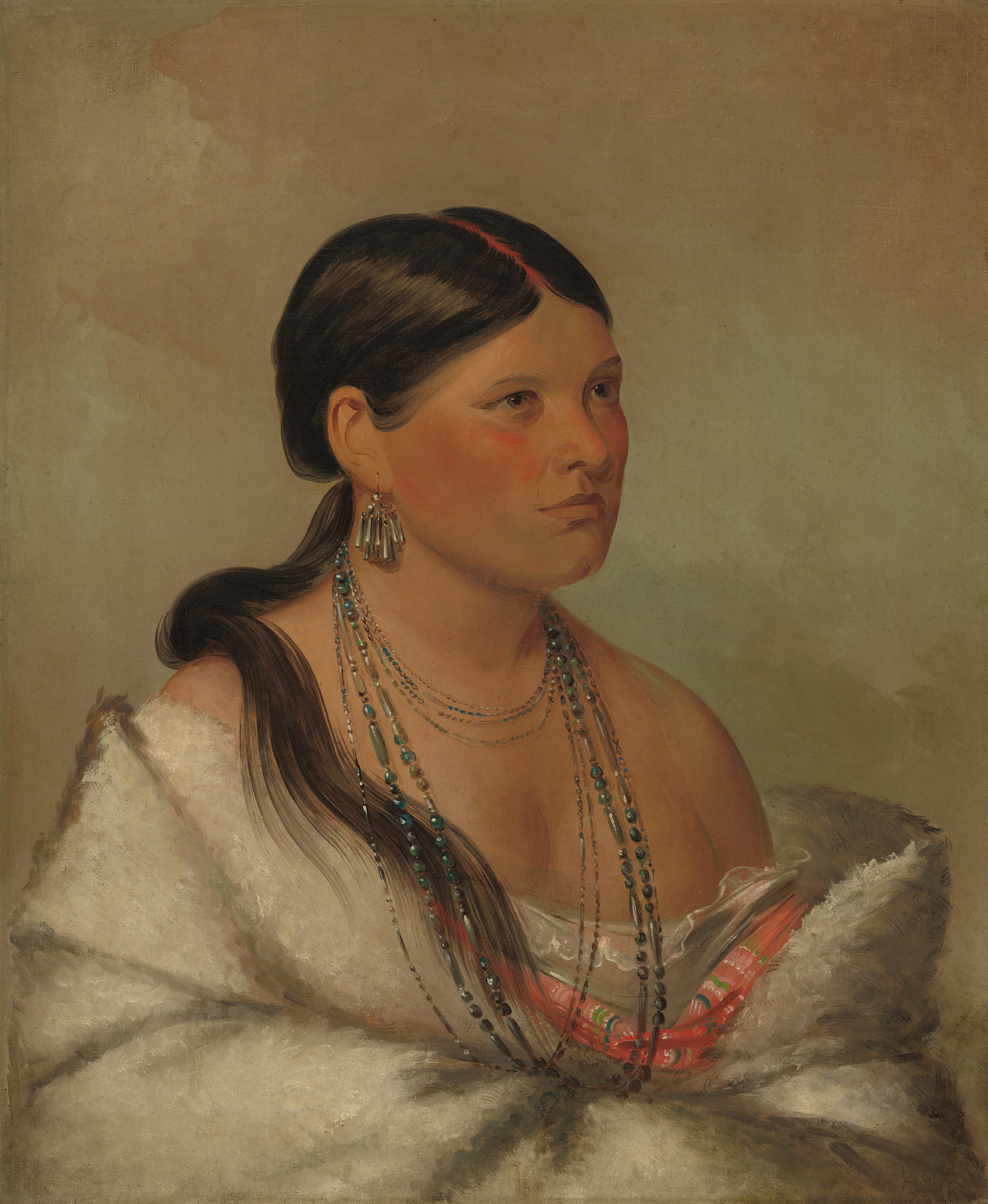 Shown from the waist up, a Shawano woman with medium-brown skin sits angled to the right and looking off in that direction in this vertical portrait painting. She has broad, flushed cheeks, light brown eyes, a cleft chin, and her lips are closed. Her black hair is parted down the middle and tied at the base of her head. A ponytail falls over one shoulder, and her part is painted red. She wears an earring made up of a cluster of long, conical silver tubes in the ear we can see. At least nine strands of delicate, blue-toned beads encircle her neck, some falling to the hollow of her throat and some reaching down her chest. Her shoulders are bare as a lace-edged chemise, carnation-pink fabric striped with blue, green, and white, and a thick white fur or fleece wrap are gathered around her arms, which appear to be crossed in front of her belly. The background is mottled with muted mauve pink and smoky turquoise blue.