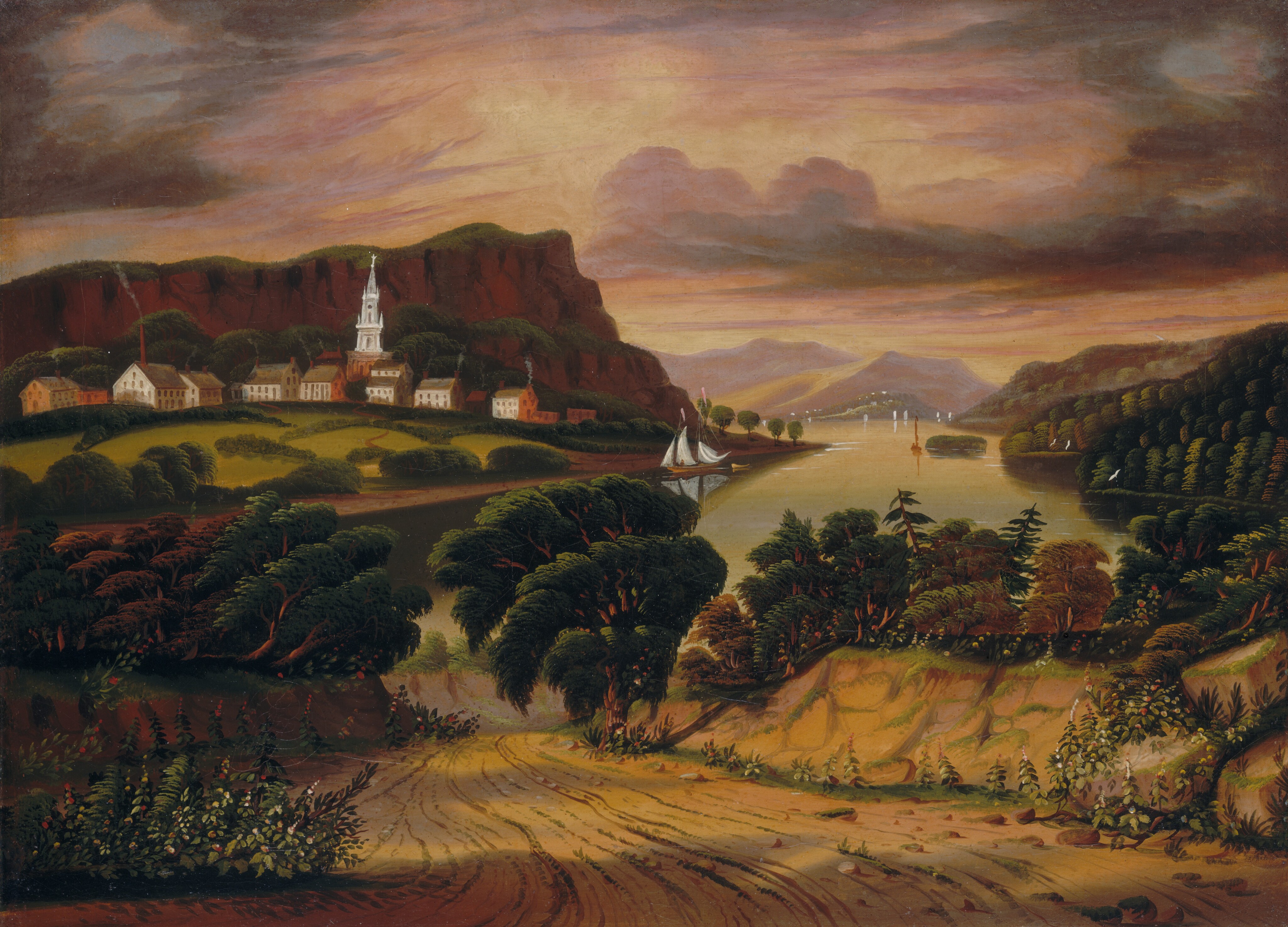 This painting features a landscape with a winding dirt path surrounded by foliage. In the background, there are hills and mountains. On the left is row of buildings below tall brown cliffs, including a white church with a steeple. A body of water with sailboats can be seen in the distance on the right. The color palette is warm, with earthy tones including greens, browns, yellow, and oranges, with shades of pink and purple in the cloudy sky.