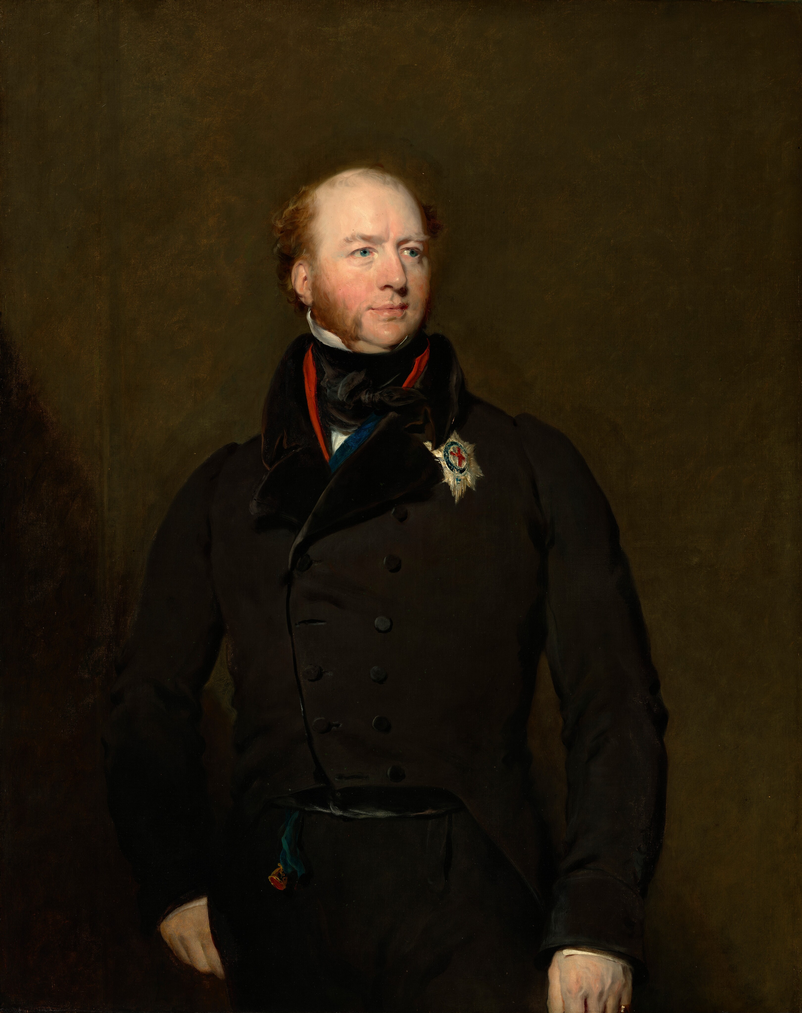 The image displays a man in a portrait from the waist up, in a three-quarter view. He is facing slightly to the right and looking into the distance with a calm expression. The man has fair skin, light reddish-brown hair, sideburns, a defined nose, and a slightly upturned chin. He is wearing a black double-breasted coat with a high collar, a dark waistcoat, a white shirt, and a medal on his chest with an insignia and ribbon. The background is plain and deep brown.