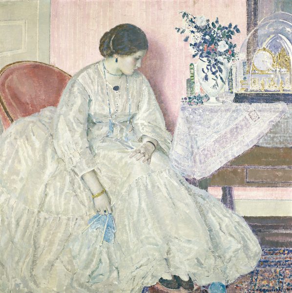 This painting shows a woman seated in a cushioned red chair, her body and head turned slightly to the right. She has pale white skin, and her dark hair is styled in an updo behind her head. She has a straight nose, small red lips, and closed eyes. She wears a long white dress with a voluminous skirt, accessorized with a black pendant on her neckline, a light blue necklace that hangs down around her neck, dark blue earrings, a blue-and-gold ring, a black bracelet, and a gold bracelet. In her right hand, she holds a section of light blue knitting with two white needles, connected to a ball of yarn by her black slippers, which poke out of the end of her skit. Behind her is a soft pink wall, with a mint green door on the right behind her chair. To her right is a wooden table covered with a white cloth. On it is a white vase filled with flowers in dark blue, green, and red, vertical shapes that may be books, and a large ornate golden clock under a clear dome. A blue, orange, and red patterned rug is visible on the floor in the bottom right corner.