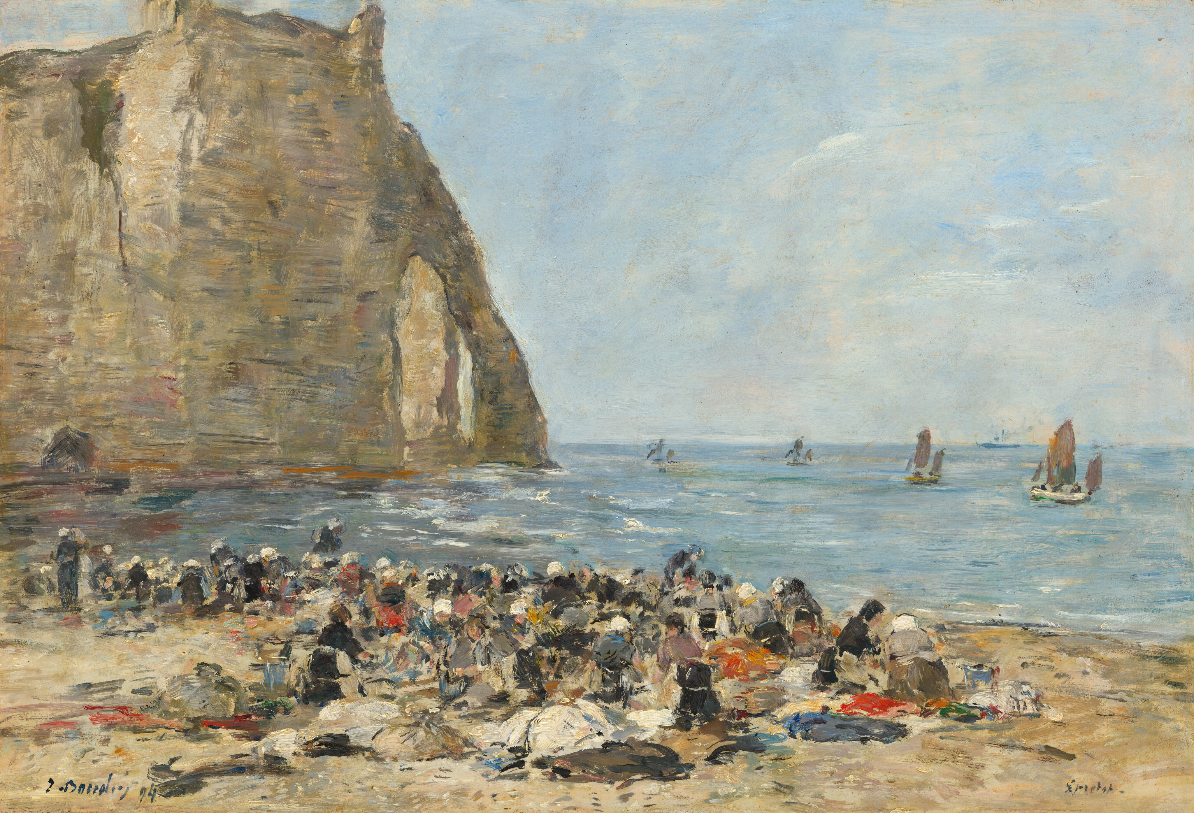 This painting shows a coastal scene with a rocky tan cliff on the left side extending down to the blue sea. The horizon is in the middle of the painting, with a bright, slightly cloudy blue sky above the sea. On the beach, a chaotic collection of dots and dashes of paint in white, black, blue, red, yellow, and pink indicate a large group of people gathered at the edge of the water. Many of the people appear to have white caps or bonnets on their heads. Behind the group of people, more smears of color suggest bundles on the beach, perhaps piles of cloth. Small gray and white boats drift on the water in the distance. The painting style is loose and expressive, with lines of color overlapping with one another. Details are suggested with dots and dashes of paint instead of being depicted clearly.