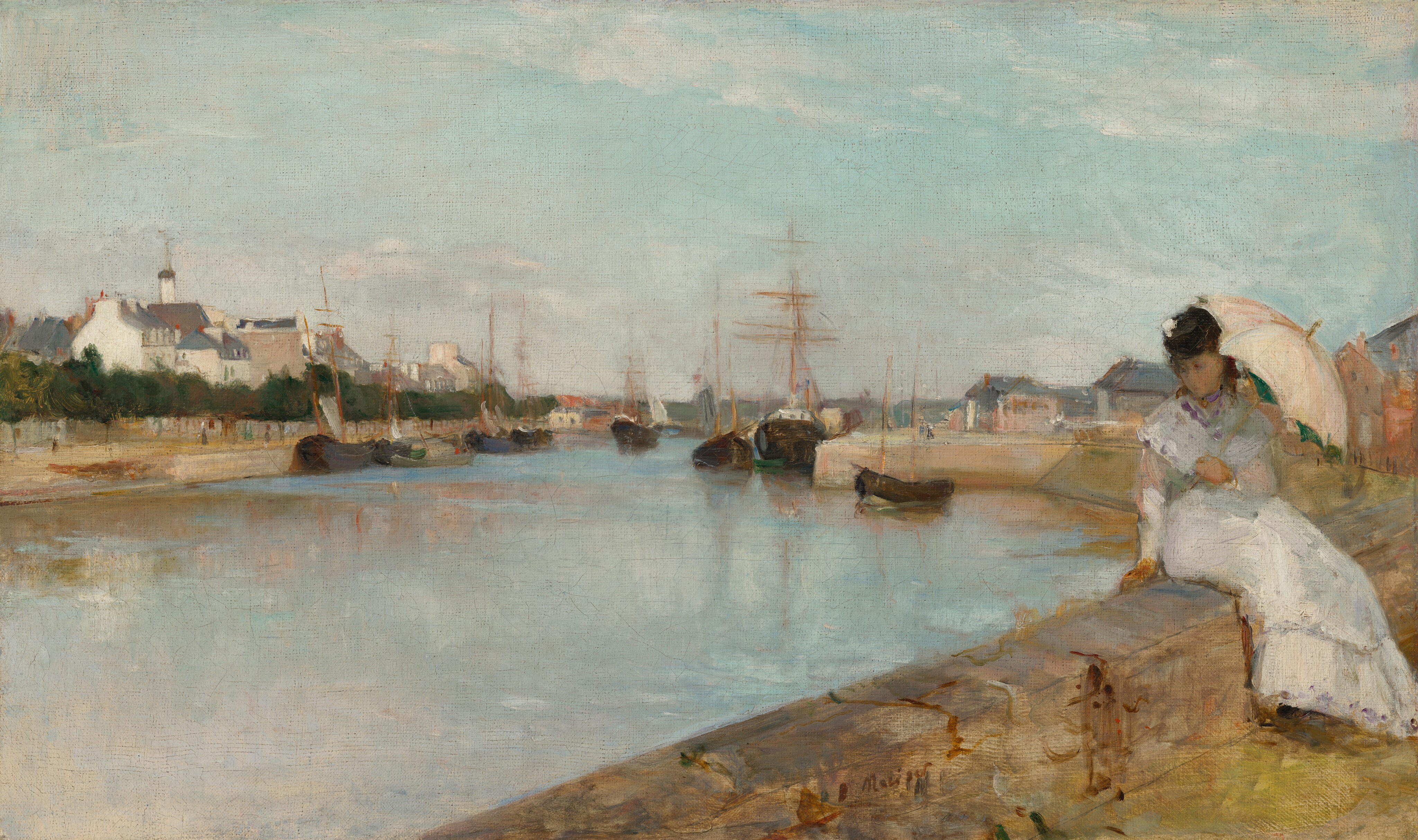 From behind a low stone wall, on which a young woman with pale skin sits, we look across a wide, shimmering blue waterway toward a town along the opposite shore, under a pale blue sky with wispy white clouds in this horizontal landscape painting. The caramel-brown, stone wall runs across the lower right corner, into the distance to our right. The woman sits on our side of the wall with her legs angled to our right, and she twists to lean onto her right hand, on our left, as she looks down toward the water. Her brown hair and face are shaded by the pale, shell-pink umbrella she holds in her left hand, to our right. She wears an ankle-length white dress with long sleeves, and a touch of white on the black hat she wears suggests it is decorated with a flower. The waterway seems to be lined with smooth walls like a canal. Ships with black hulls and wooden masts nearly span the passageway and reflect in the surface of the water beyond the woman. The shore across from us is lined with a row of deep green trees in front of a cluster of cream-white buildings with charcoal-gray roofs. More buildings are visible in the distance on our side of the waterway. The scene is loosely painted so many details are difficult to make out, especially in the woman’s face. The artist signed the work in dark paint at the lower center: “B Morisot.”