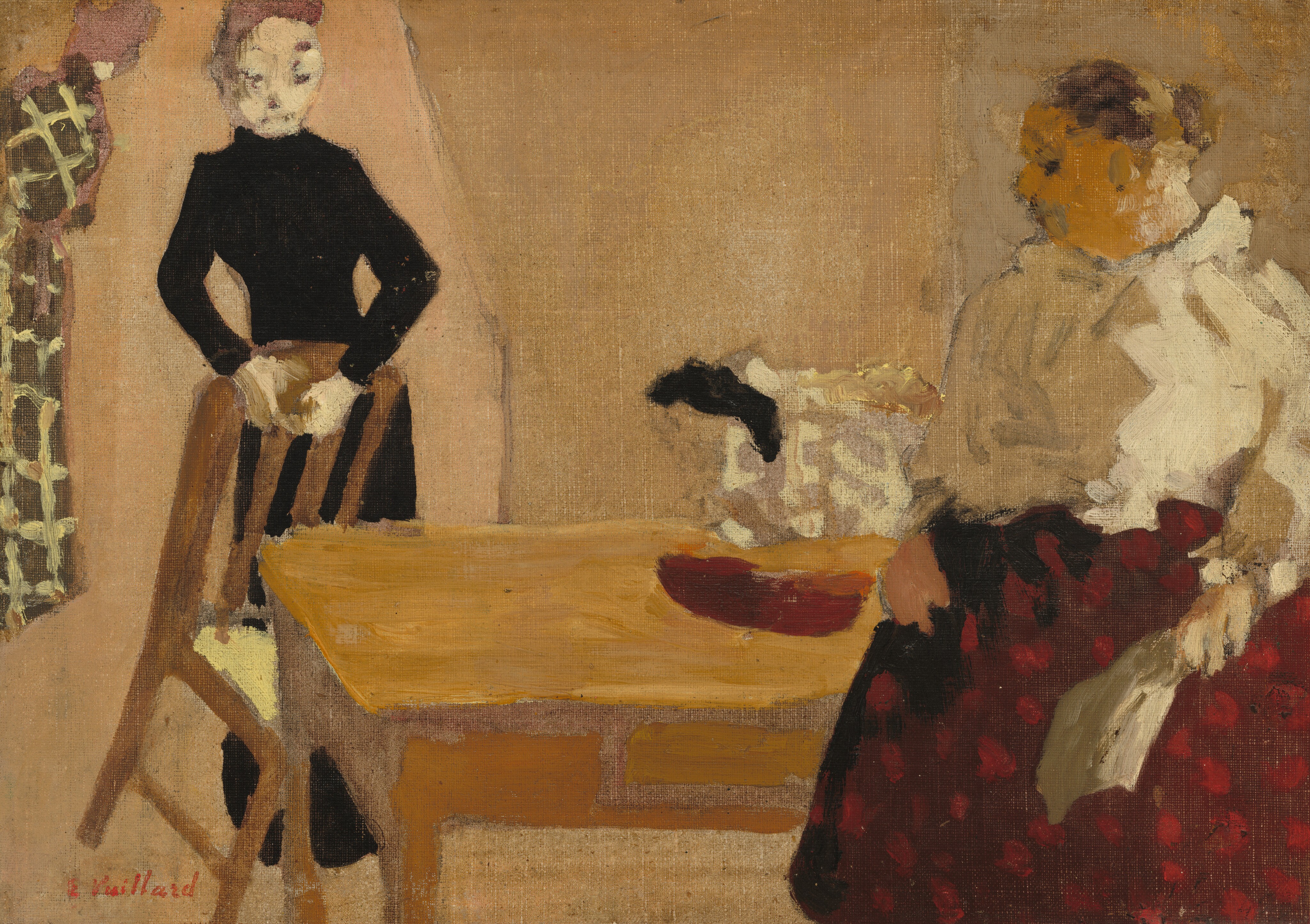 Two people are depicted in this painting. The person on the left is standing with their hands on a wooden chair. They have light skin, close-cut hair, and wear a long, black, high-necked dress. The person on the right is seated or standing in front of a wooden table. They wear a white ruffled top and a dark red skirt with lighter red spots, and their hair is styled back in a bun. Their skin is pale yellow, and they hold a light-colored piece of fabric or paper. The two people are looking towards each other. On the table between the two people there appears to be a red bowl and a patterned, off-white object with a black handle. In the background are muted beige walls with a brown and white patterned object near the top left corner. The paint has been applied in thick brushstrokes, and the people and objects lack detail.