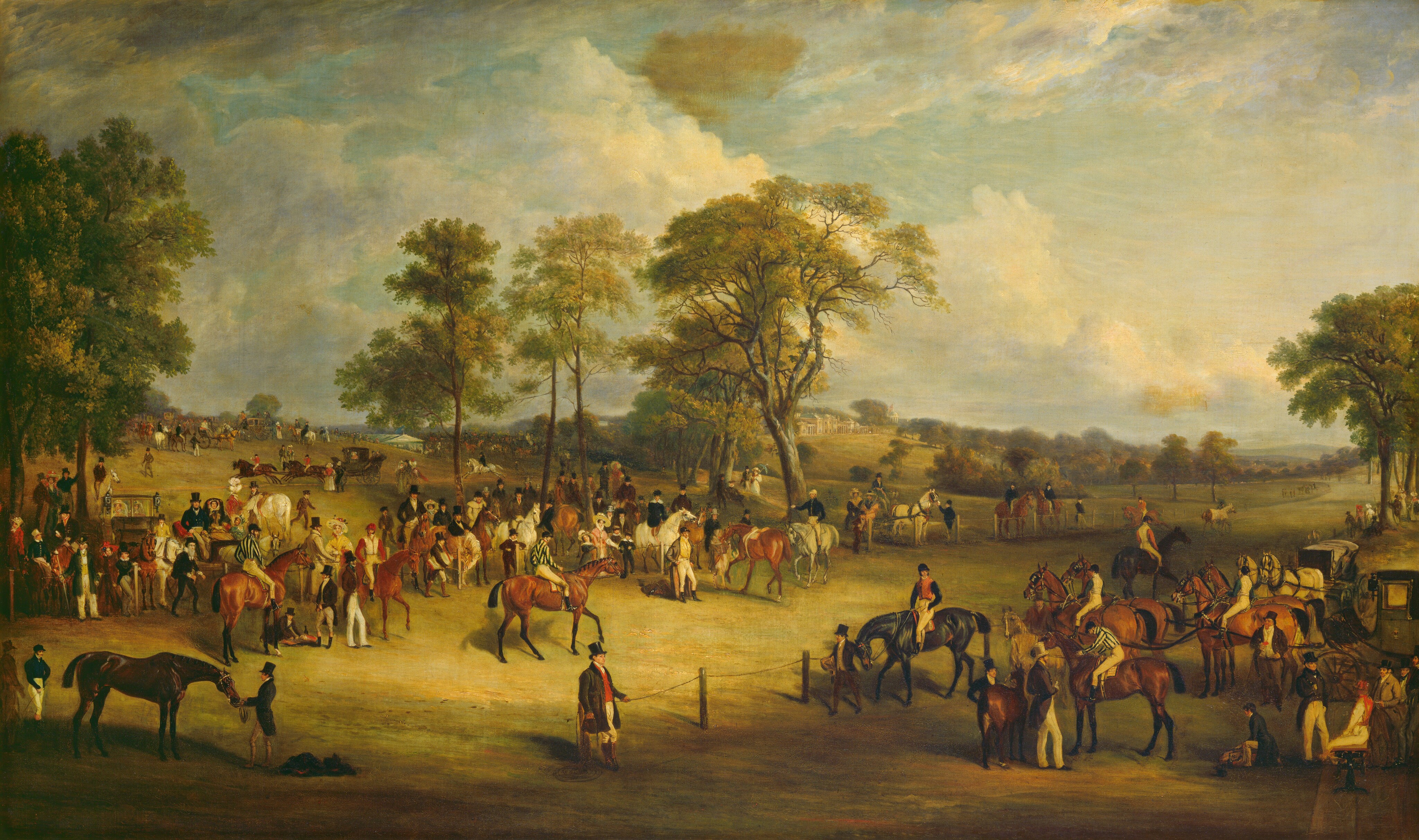 The painting depicts an equestrian scene with people and horses in a green landscape. There are several people on horseback, and others standing by horses. Some people are also sitting in horse-drawn carriages. The horses are in a variety of colors, and the people wear formal clothing like suit jackets, top hats, vests, or colorful dresses. People fill the middle of the scene and the green hills that rise to the left, while a wide path is marked off on the right, bordered by fences. There are some tall trees around the area, with people gathering below them. In the distance, a large white building with columns and blue roofs can be seen. There is also a white tent partially behind a hill on the left. The sky above is blue and filled with white and gray clouds.