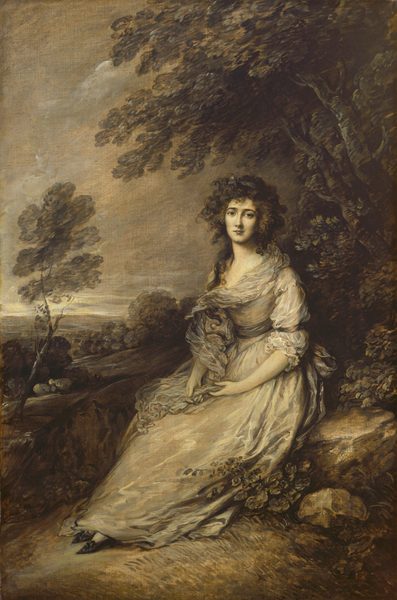 The image depicts a woman seated outdoors. She is looking directly at the viewer with a serene expression. She has soft facial features, full lips, and expressive eyes. Her hair is voluminous and curls around her face and shoulders. She wears a light-colored gown with sheer sleeves and a fitted waist. The background shows trees and foliage, with a distant horizon visible. The scene conveys a peaceful moment in nature.