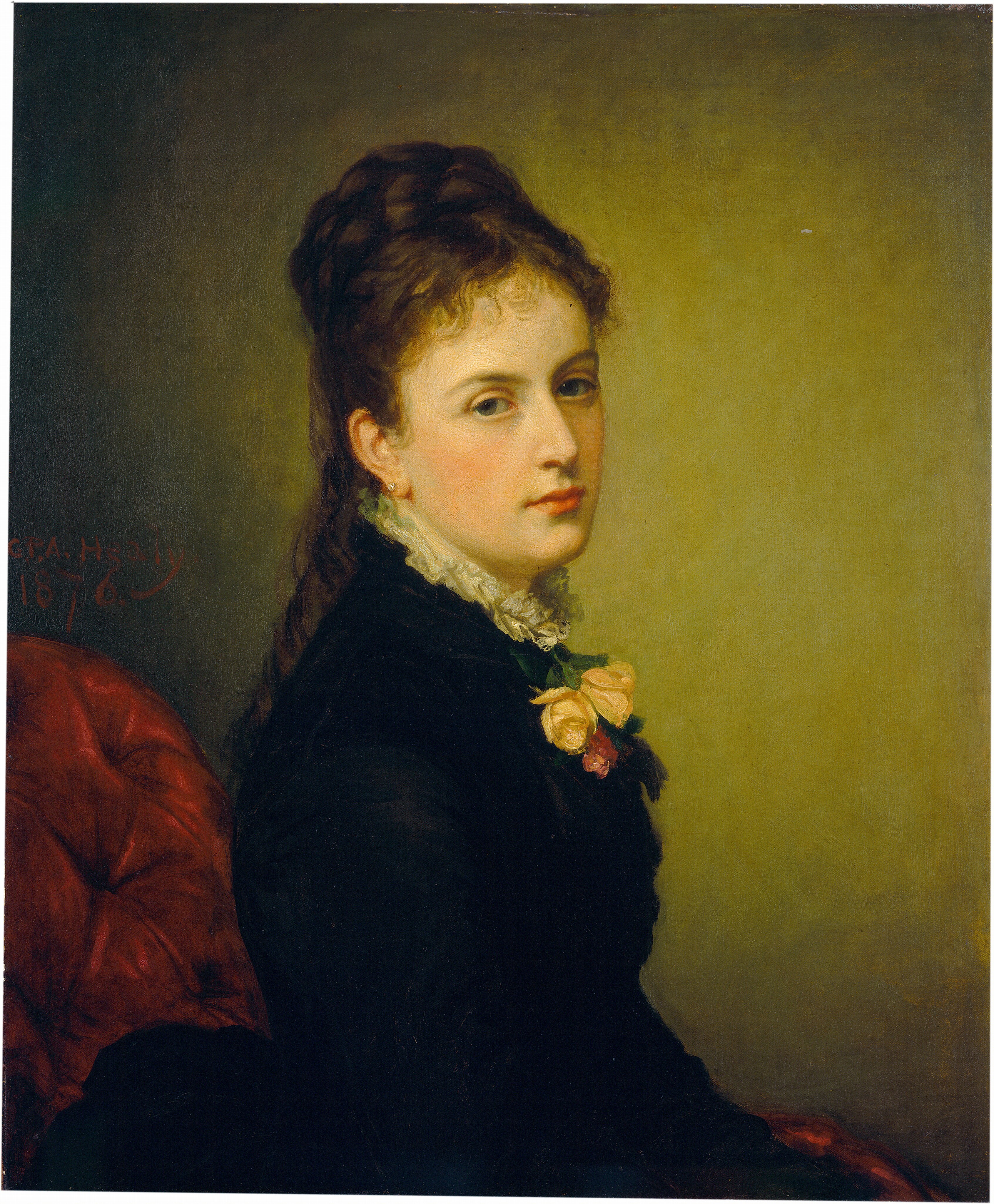 The image displays a woman in a side profile position, with delicate facial features, fair skin, rosy cheeks, and lips. She has dark, wavy hair styled away from her face, wearing a high-collared black dress with a white ruffled trim. Two roses, one yellow and one pink, are pinned to her chest. The background is muted green with part of a red chair visible behind her. The artist's signature and the year "1876" are inscribed in the top left corner.