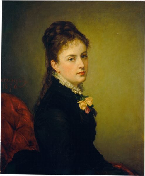 The image displays a woman in a side profile position, with delicate facial features, fair skin, rosy cheeks, and lips. She has dark, wavy hair styled away from her face, wearing a high-collared black dress with a white ruffled trim. Two roses, one yellow and one pink, are pinned to her chest. The background is muted green with part of a red chair visible behind her. The artist's signature and the year "1876" are inscribed in the top left corner.