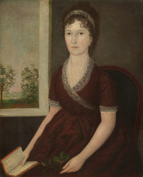 This painting shows a seated woman depicted from the knees up. She is sitting in a dark reddish-brown chair with a dark green cushion, her body turned slightly to the left, facing the viewer. She has both arms resting on her lap, her left hand holding a small twig with round green leaves and her right hand holding a small book open. She has light skin, dark brown eyes, thin eyebrows, thin pink lips set in a neutral expression, and dark curly hair styled away from her face and adorned with a white headband. She wears a dark red dress with lace detailing around the neckline and the cuffs of the short sleeves. The background features a dark gray wall on the right, with a white window on the left providing a view of an outdoor scene with leafy green trees and a sky that is a gradient of light gray and light blue, with light pink at the horizon.