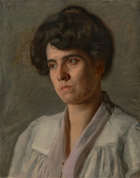 This painting is a portrait of a person with dark hair styled neatly in an updo with soft waves over their forehead. They have a serious expression, with pale skin, high cheekbones, deep-set eyes, dark eyebrows, and pink lips in a neutral expression. The person is wearing a pale blue garment with a vee-neck and slightly puffed sleeves, and they are turned slightly to the left. On the right, there are deep shadows on the side of their face and their neck. The background is a mixture of brown and gray shades with visible brushstrokes.