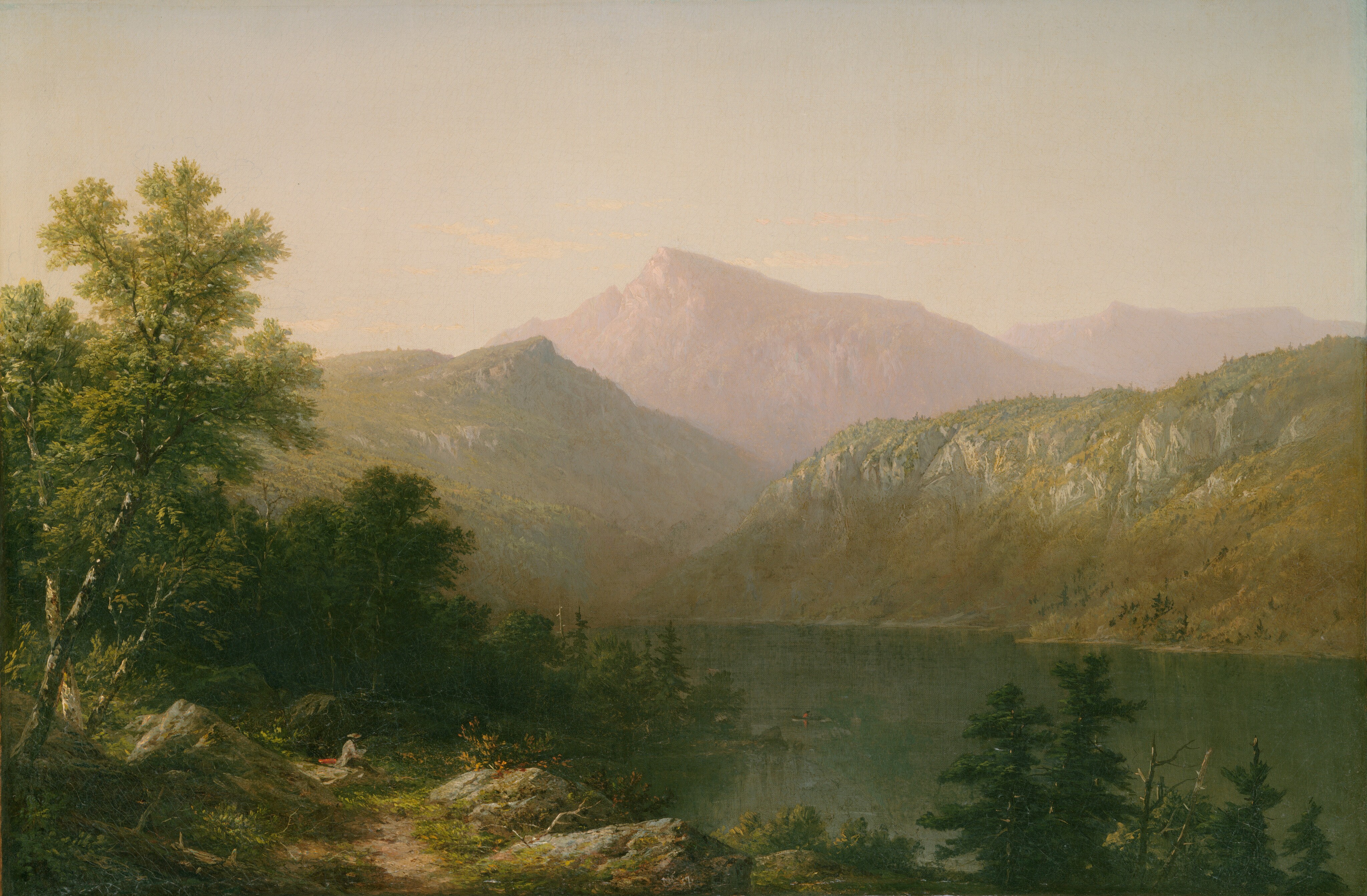 A lake stretches from a spit of land in the lower left corner of this horizontal painting to hills and mountains that rise precipitously on the far bank in this hazy landscape. A dirt path winds through the grassy area between boulders and trees in the lower left corner. Tiny in scale, a person wearing a brown brimmed hat, a tan-colored jacket, and darker pants sits on a rock facing the water. A red object, perhaps a bag or portfolio, lies next to him, and he holds a rectangular object, perhaps a paint palette or sketchbook. Sunlight slices through the trees, low to the ground, to highlight the upper surfaces of the grass and stones while throwing the far side, facing the lake, into deep shadow. A person wearing a red jacket or shirt and a dark hat rows a canoe on the placid, muted blue lake. Sunlight warms the left-facing sides of the grassy, tree-dotted hills on the lake’s far shore, Taller, craggier mountains are smoky plum purple against a hazy, watery blue sky. The artist’s conjoined initials, “JWC,” are painted with white in the lower center of the canvas, as is the date, “57.”