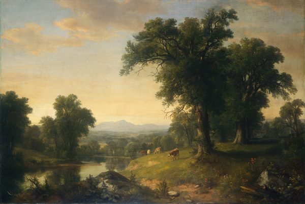 A placid river winds past low hills with cows to fields blanketed with trees leading back to mountains lining the horizon in this hazy, horizontal, landscape painting. The river curves in a tight backward C shape from the lower left corner of the composition. The right half of the foreground closest to us is made up of a gently sloping, grass-covered hill alongside the water. Four cows graze in the sunshine closer to the water, and the right portion is in deep shade under towering trees that nearly fill the right half of the composition. Logs, moss-covered boulders, stones, and plants line the bottom edge of the painting. Languid, golden light works across the treetops in the middle distance. The mountains along the horizon, which comes about a third of the way up this painting, are slate gray. The sky above is streaked with pale yellow near the horizon and deepens to pale blue along the top edge of the canvas. A few deeply shaded, ivory-yellow clouds float across the sky. The artist signed and dated the painting in the lower center, “A B Durand 1858.”