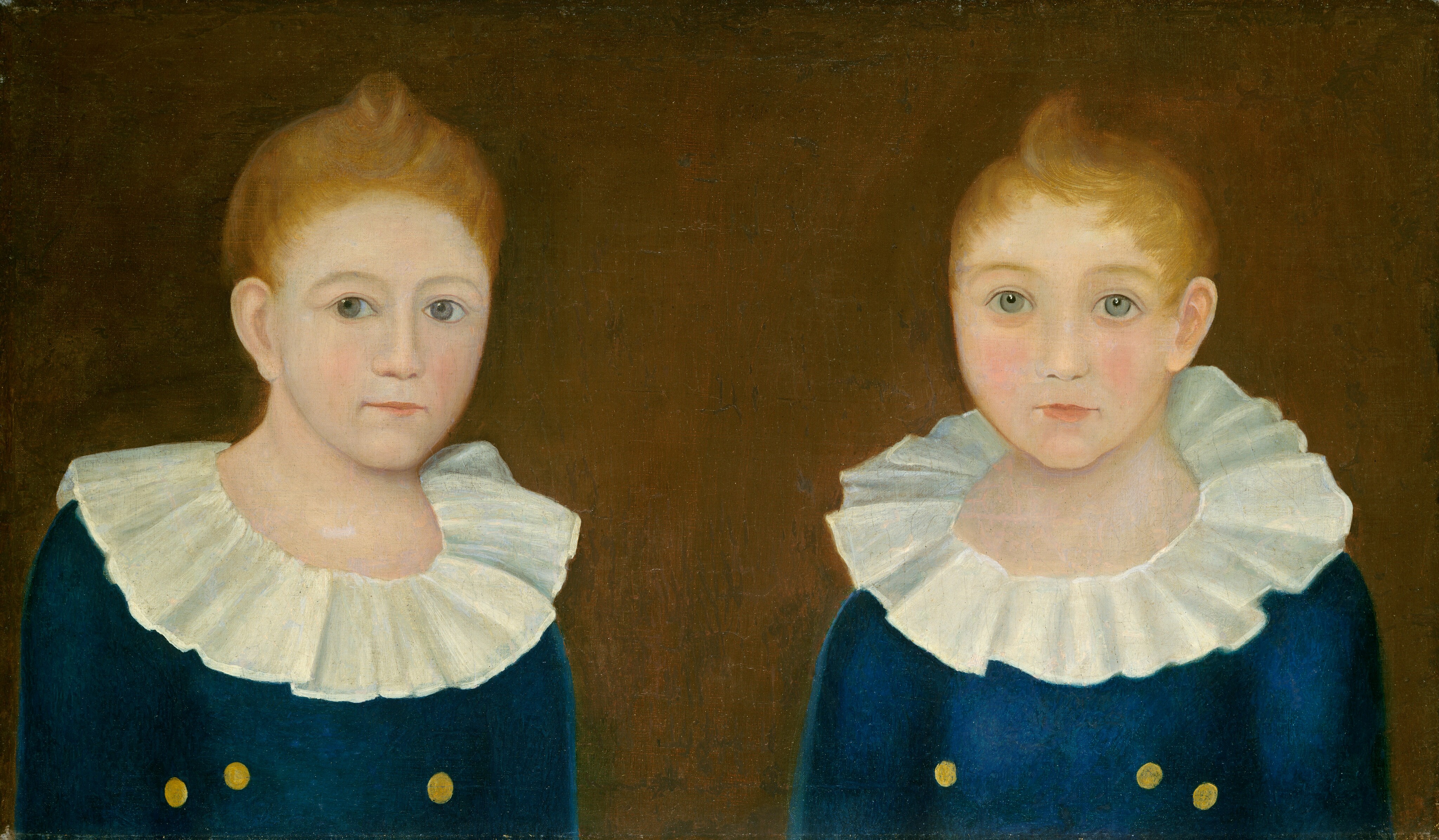 The image depicts two individuals standing side by side. They both have light brown hair, light skin, round eyes, and slightly flushed cheeks. They are wearing deep blue garments with white ruffled collars and two yellow buttons. The background is a flat, dark brown color.