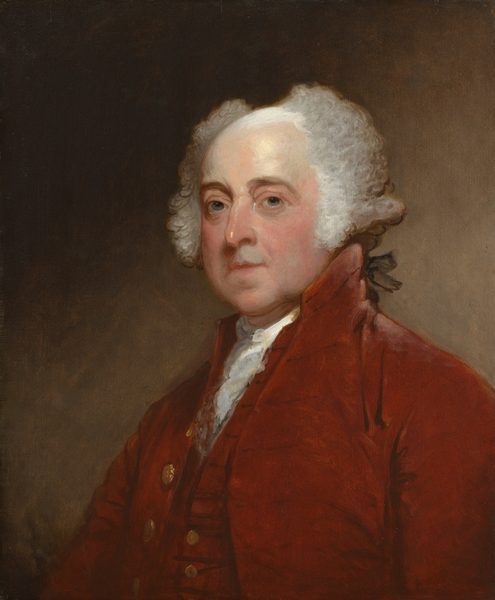 Shown from the chest up, a balding, light-skinned man wears a port-red vest and coat in this vertical portrait painting. The man’s shoulders are angled to our right, but he turns his head to look at us from the corners of gray eyes under heavy, brown brows. His under-eyes are shaded blue and lined with wrinkles. He has a bumped nose, bow-shaped lips, a round chin, fleshy, flushed cheeks, and sagging jowls. His white hair sweeps up and to either side of a bald patch, painted with a white sheen, on the top of his head. Curls come down over each ear and longer hair in the back is tied with a black ribbon. He wears a white ruffled cravat under the deep red vest and coat, both of which have gold-colored buttons down the front. The background lightens from earth brown in the upper left corner to paler, peanut brown in the lower right.