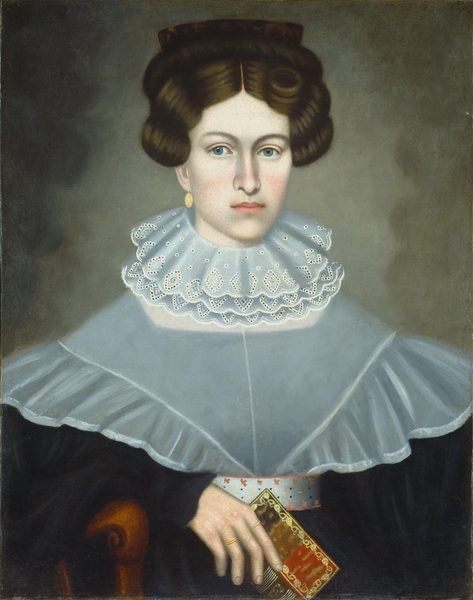 The image shows a woman portrait from the waist up. She is seated upright, holding a book in her left hand. She has blue eyes, dark brown hair styled with rolls and a braided crown, and wears elegant 19th-century clothing with a lace collar, a blue-gray garment, and gold earrings. The background is plain, and she is seated on a wooden chair.