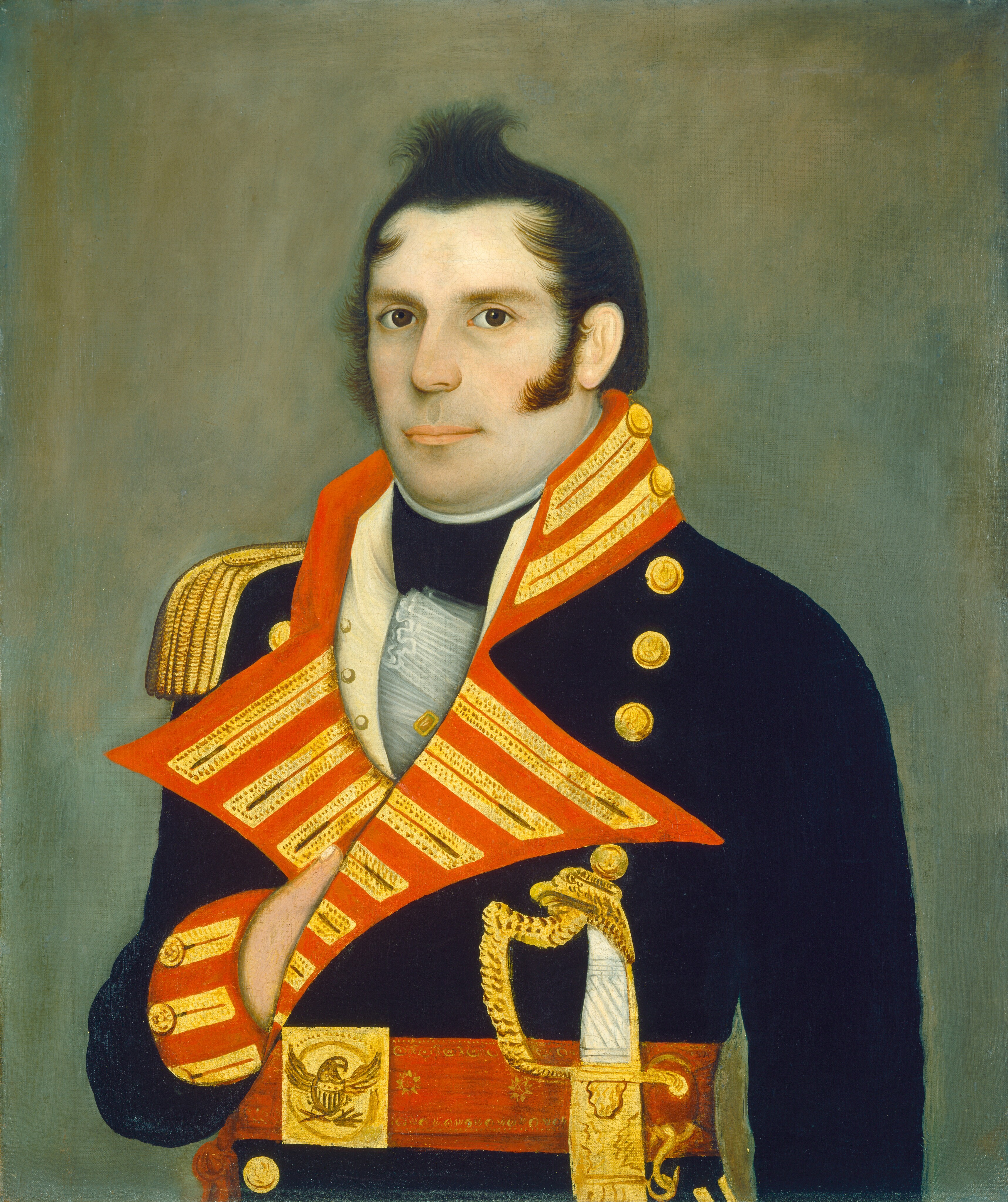 The painting depicts a person from the waist up with a fair complexion, sideburns, dark combed-up hair, and a neutral facial expression. The individual's left hand is resting on the front of a brightly adorned military jacket. The jacket features red and gold decorations, gold shoulder epaulettes, a high collar, gold buttons, a white cravat, a decorative sash across the chest and waist, a sheathed sword attached to the waist, and an intricate gold belt. The background is a plain, muted gray.