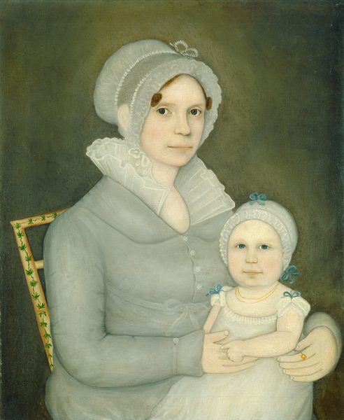 The image depicts a woman seated with an infant on her lap. The woman is facing slightly to the left with her head turned towards the viewer. She has a calm expression with large eyes, thin lips, and dark hair under a lace-trimmed cap. She wears a high-collared dress with buttons and a shawl around her shoulders. The infant gazes directly at the viewer, wearing a bonnet with light blue ribbons and a white dress with a gold necklace. The woman's hand rests on the child, with a gold ring on her finger. The background is a dark, textured tone with a decorative chair featuring green, leaf-like designs.