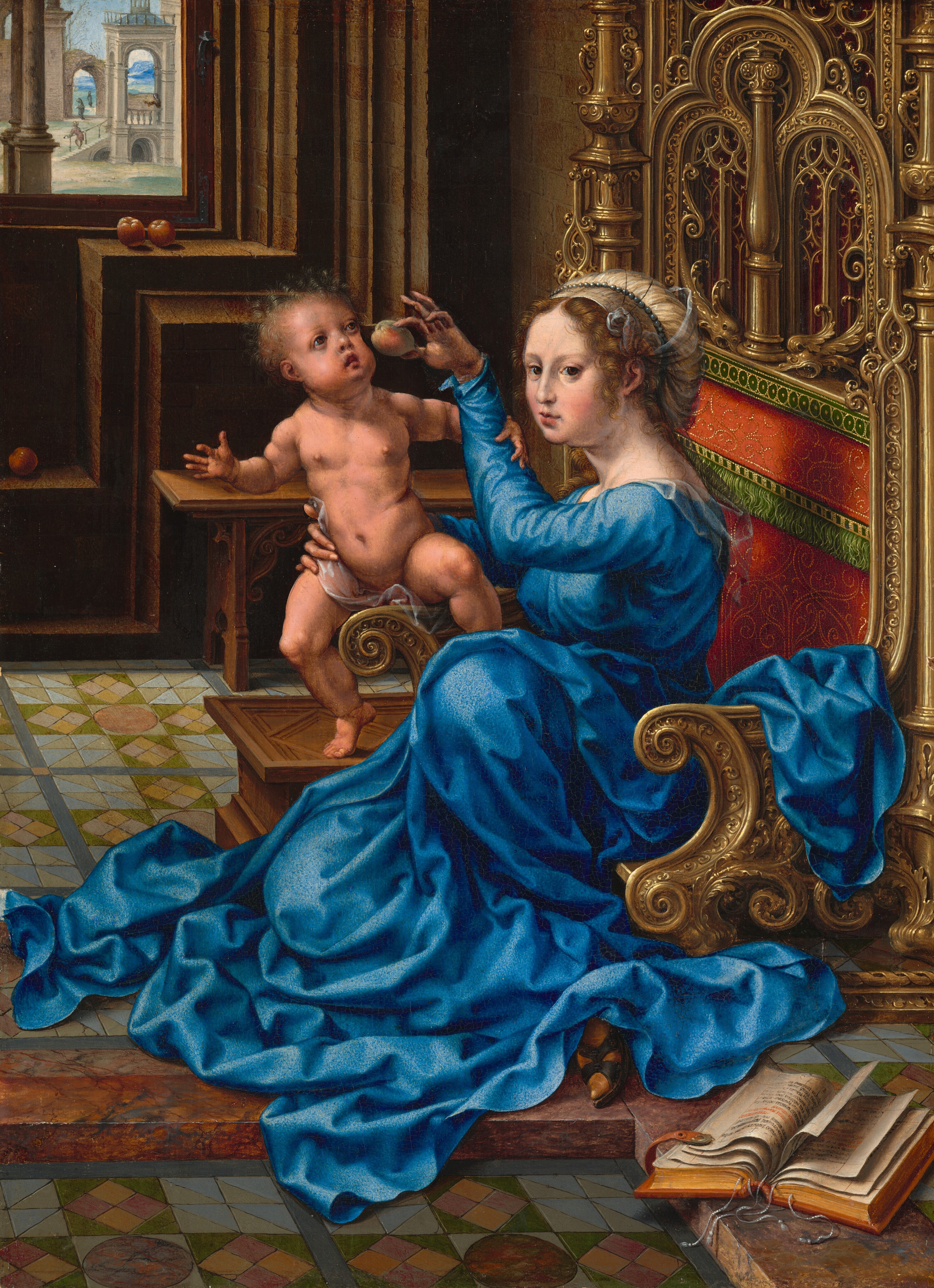 A light-skinned woman wearing a lapis-blue dress sits on a throne, holding a nearly naked pale-skinned baby in this vertical painting. The woman’s long-sleeved dress falls in lively folds as it pools around her legs and feet. Curling tendrils frame her face while the rest of her brown hair is pulled back beneath a cloth headdress. Her body is angled to our left and she looks off just over our left shoulder. She supports the baby who straddles the right arm of the chair and balances on the toes of his right foot. With her right hand, the woman holds a piece of fruit, perhaps a small apple, up by the baby’s mouth. The throne sits low to the ground and is ornately carved and gilded with scrolling arms and intricate tracery up the back around the crimson-red, upholstered center. They sit in a room with a patterned tile floor, thick, brown stone walls, and a window with a view onto other buildings and people in the upper left corner. Three more apples rest on ledges near the window. A thick book lies open in the bottom right corner.
