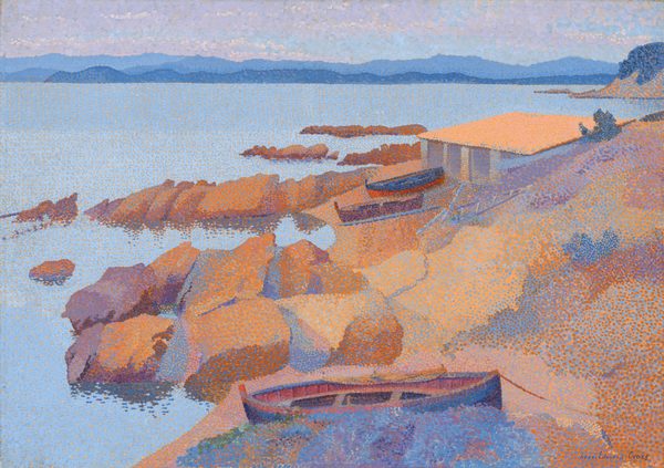 The painting depicts a coastal scene. A rocky shore in warm tones of orange, brown, red, and purple is closest to us, with two boats and a simple structure visible near the center of the painting. There is another boat closer to us, by the water near the bottom edge of the painting. The horizon line is almost at the top of the painting, with a range of mountains faintly visible against a strip of pale-purple sky, past the large body of water. The water is a light blue color, stretching from the rocky shore on the right to the distant mountains. The paint has been applied with small dot-like brushstrokes of reds, oranges, blues, and purples.